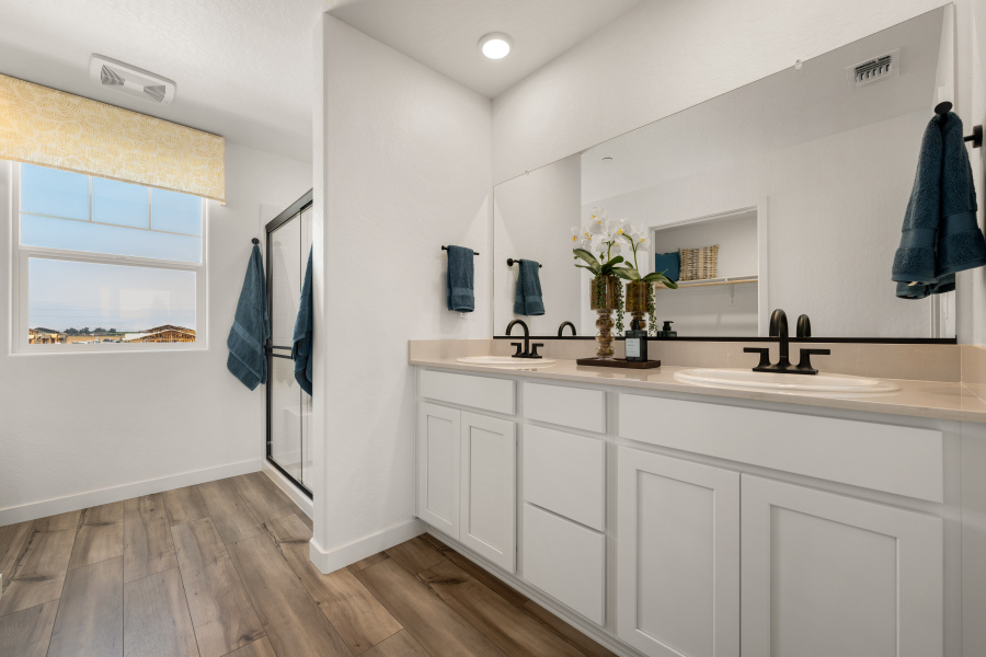 A bathroom with white cabinets.