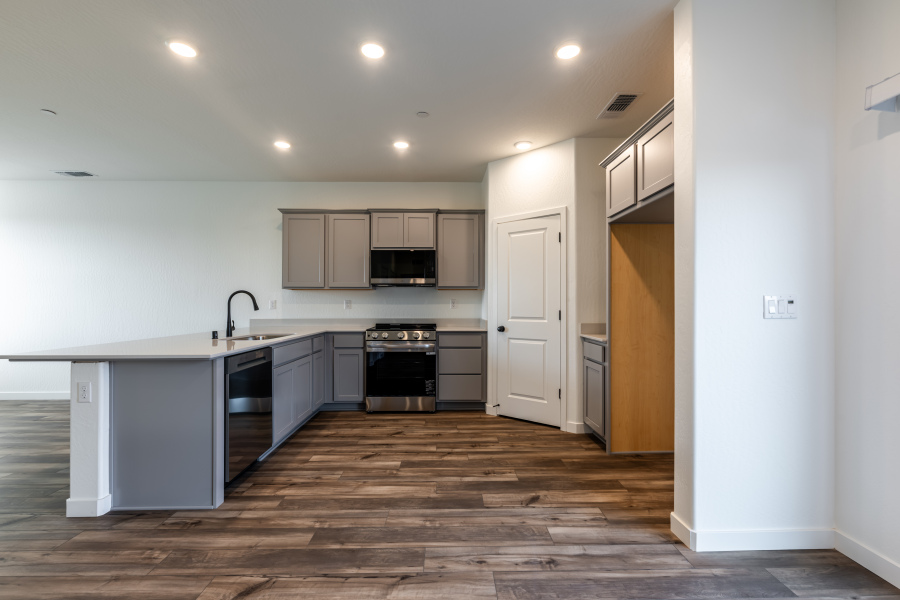 A kitchen with white cabinets.