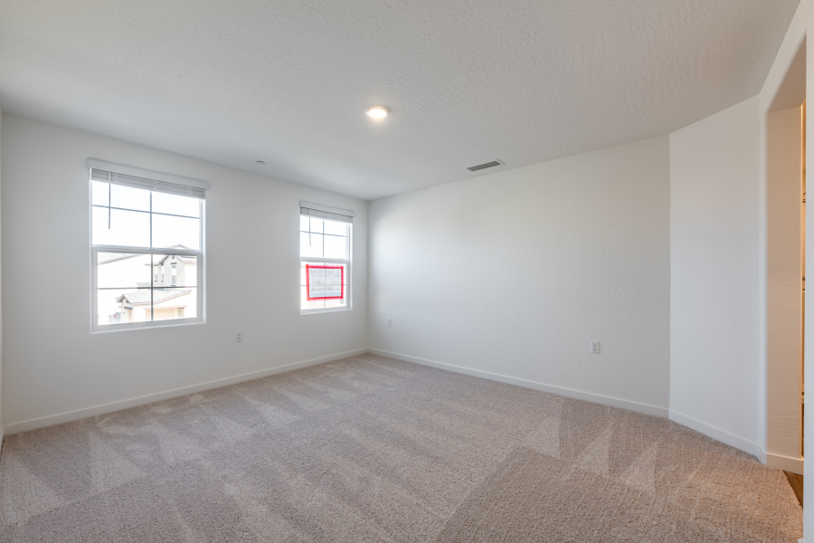 A room with windows and a carpet.