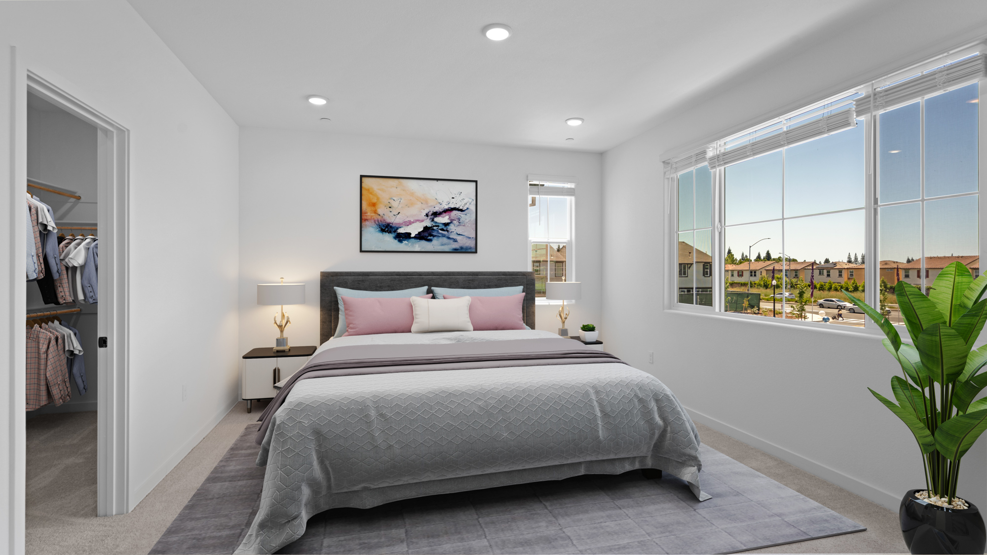 A bedroom with a large window.