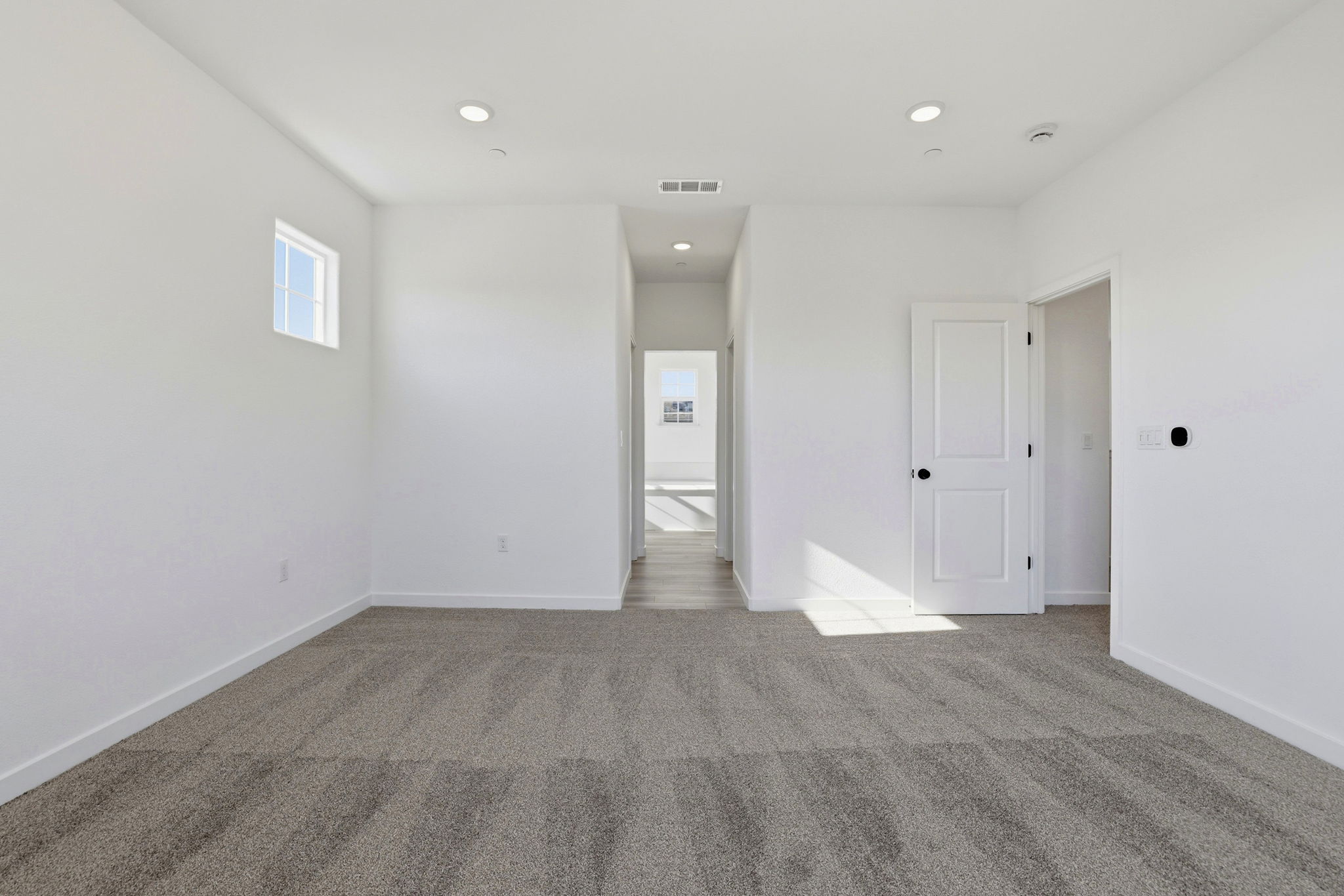 A hallway with white doors.