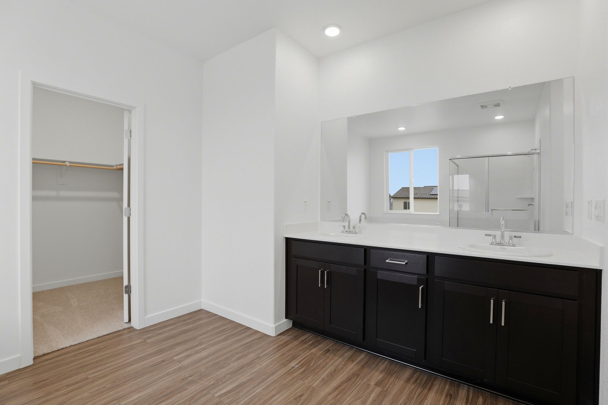 A bathroom with a large mirror.