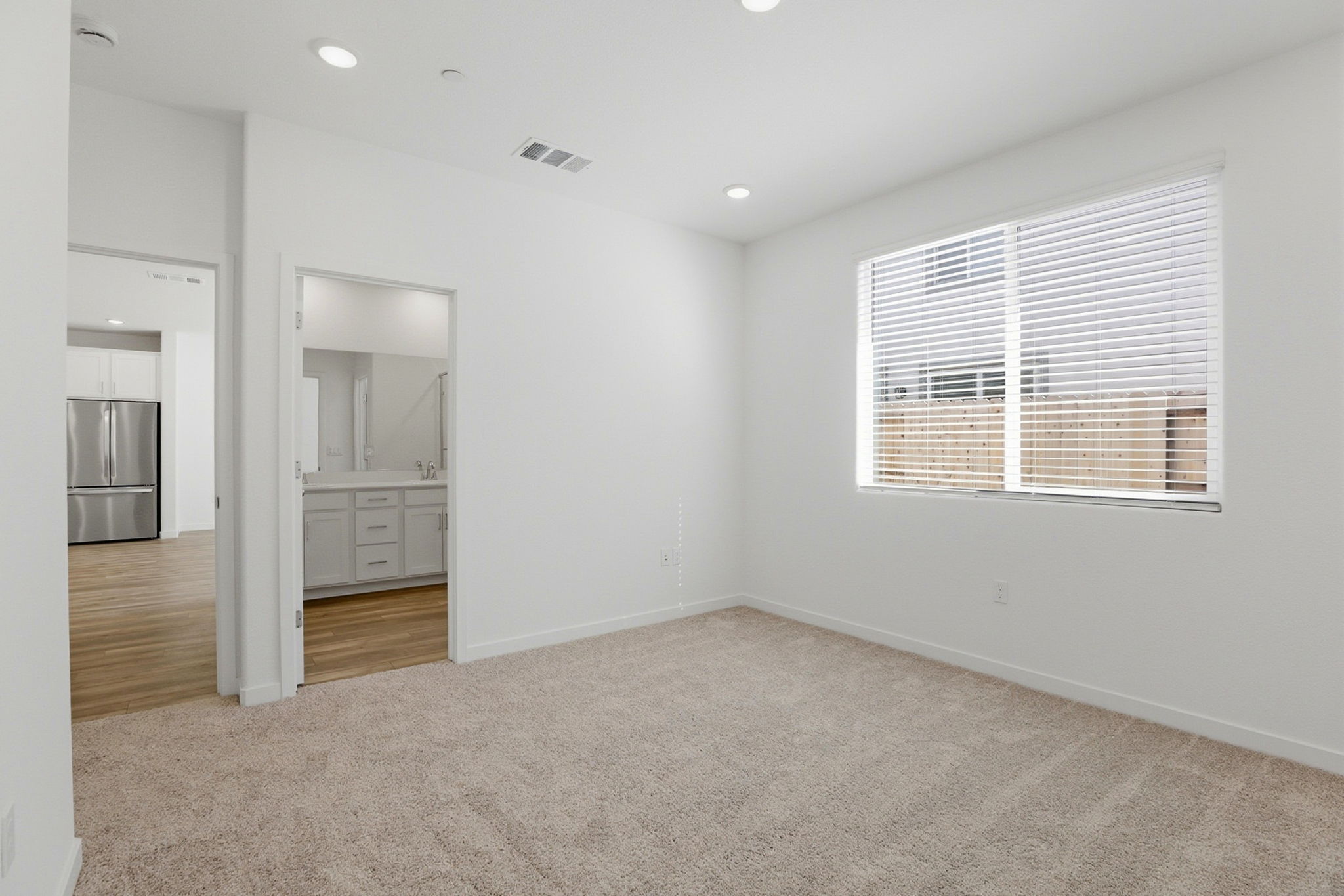 A room with a window and a door.