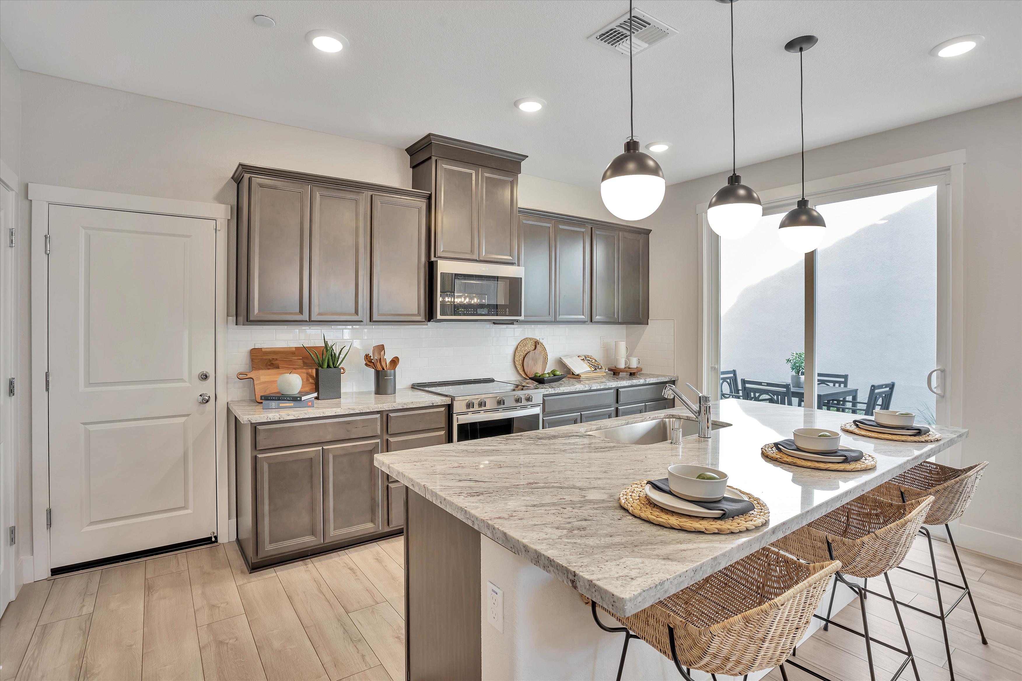 A kitchen with a marble island.