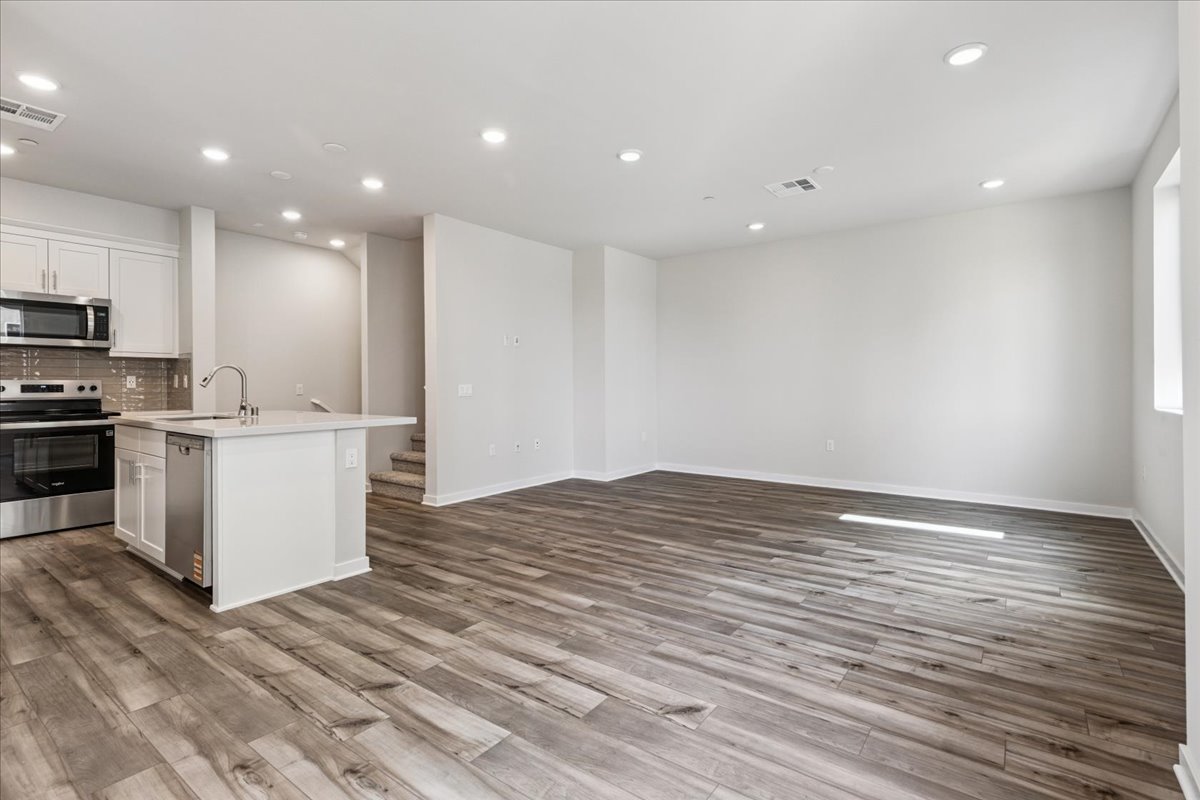 A kitchen with white cabinets.