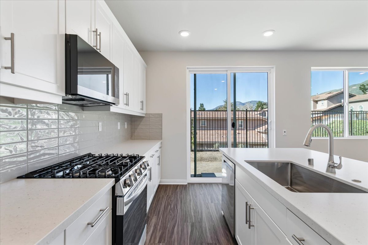 A kitchen with white cabinets.