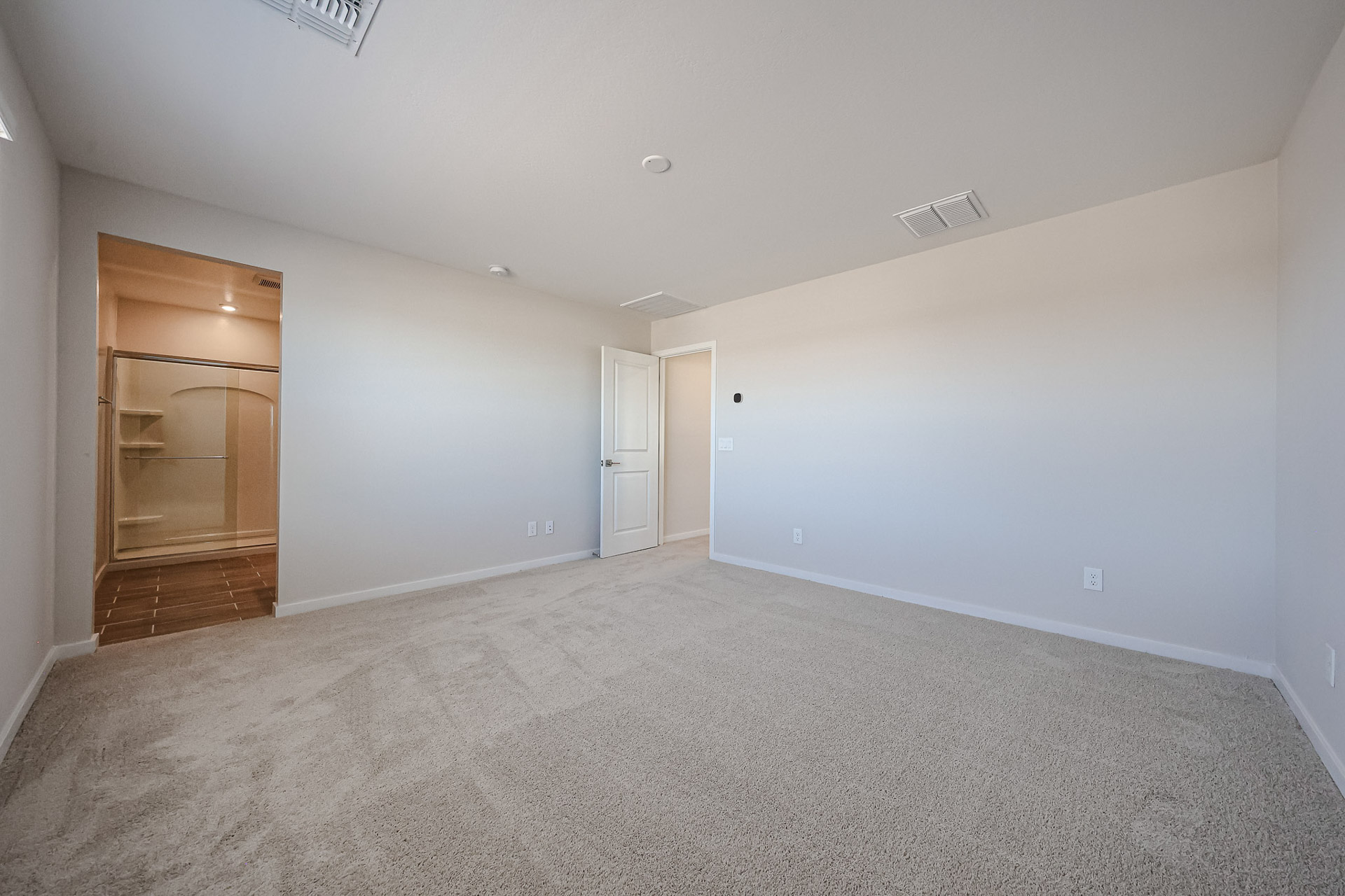 A room with white walls and a wood floor.
