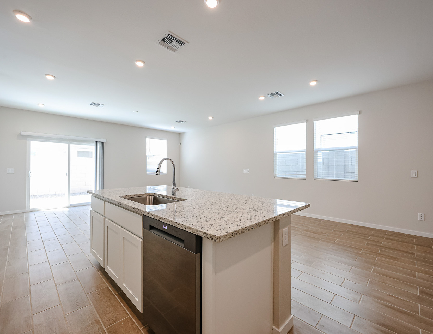 A kitchen with marble counters.