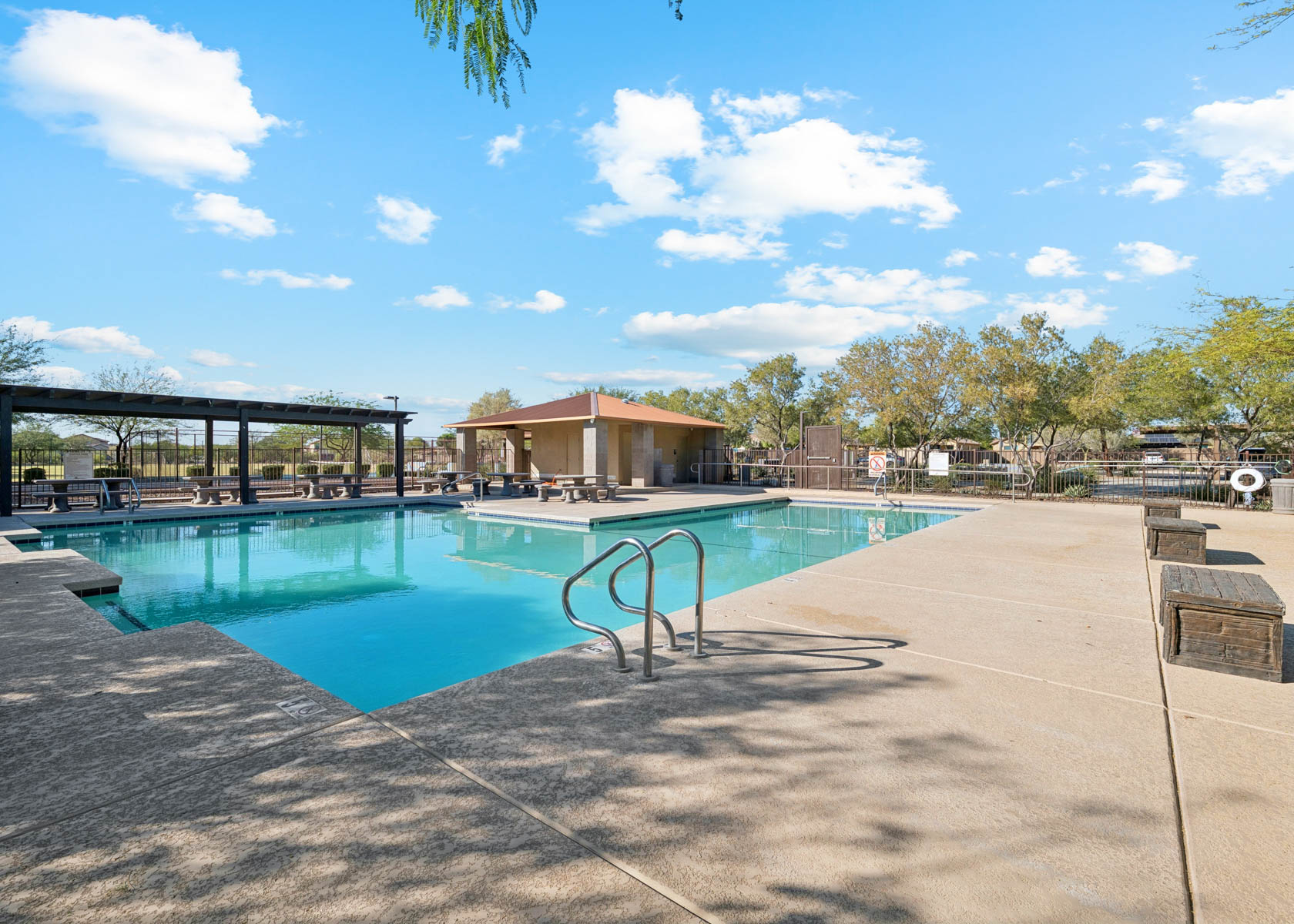 A swimming pool with a building in the background.