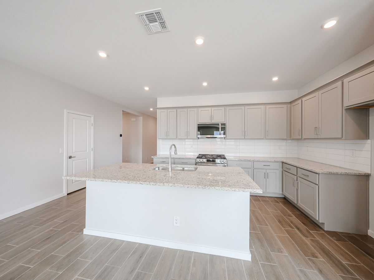 A kitchen with white cabinets.