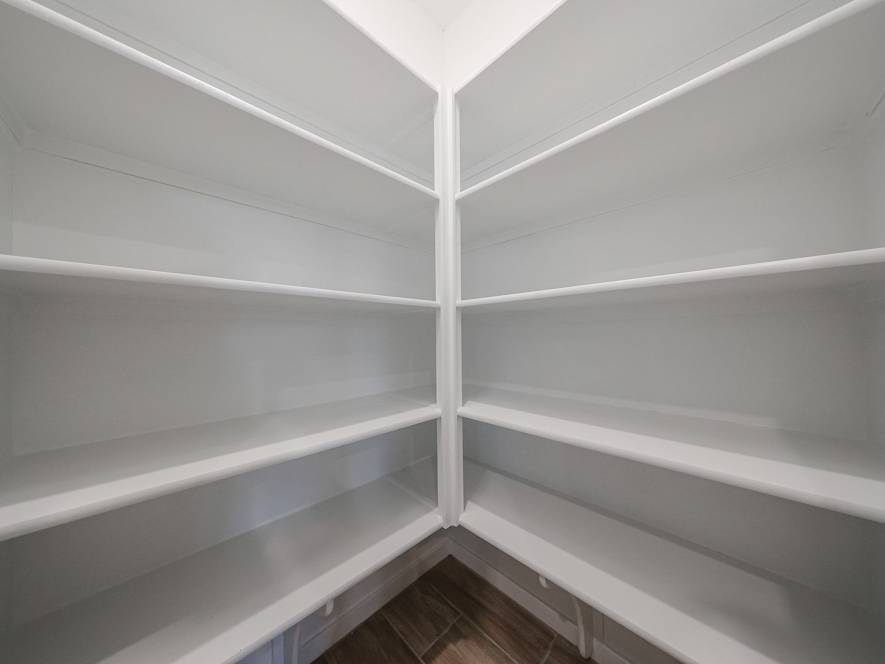 A white ceiling with a wooden floor.