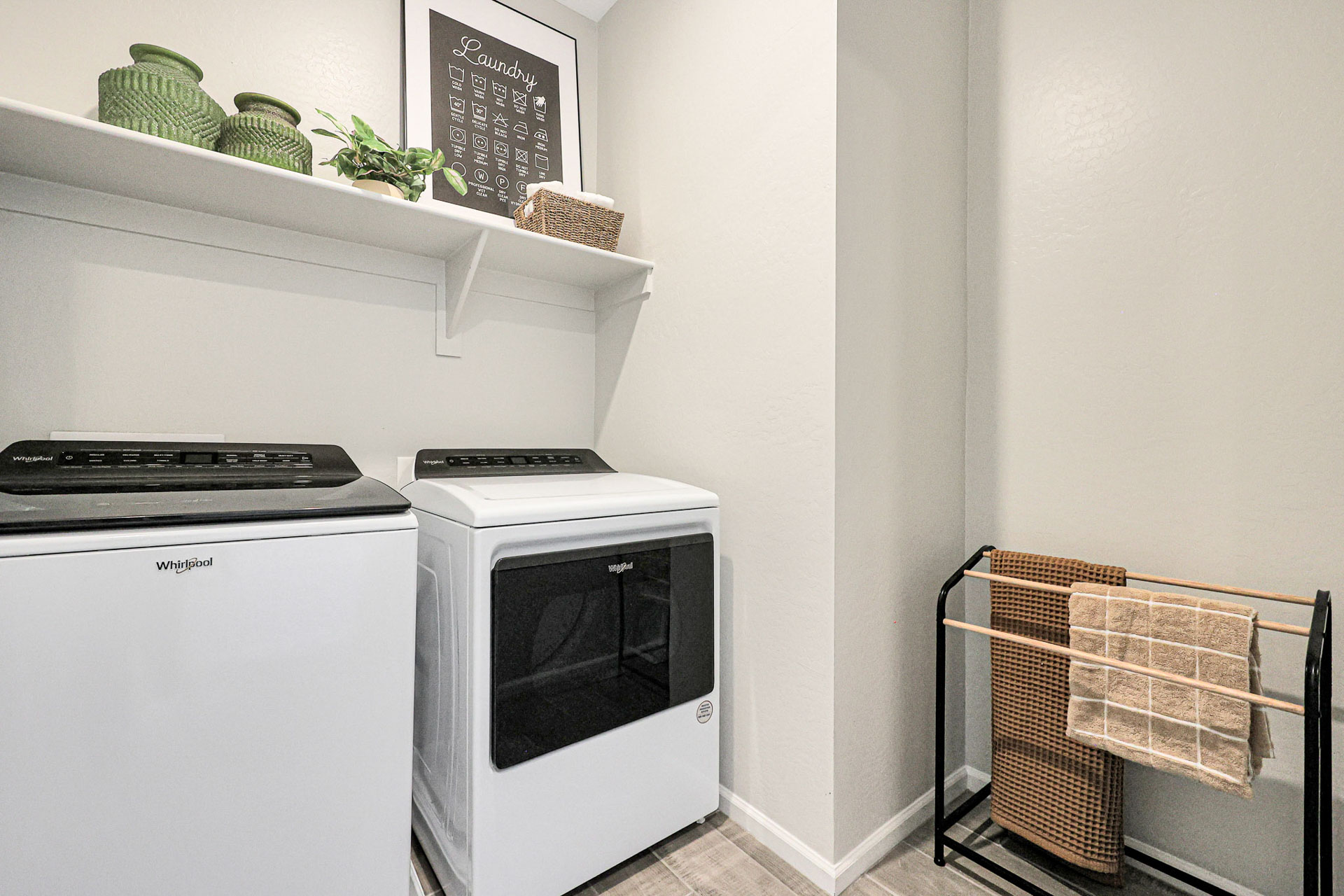 A kitchen with a white stove and a white shelf.