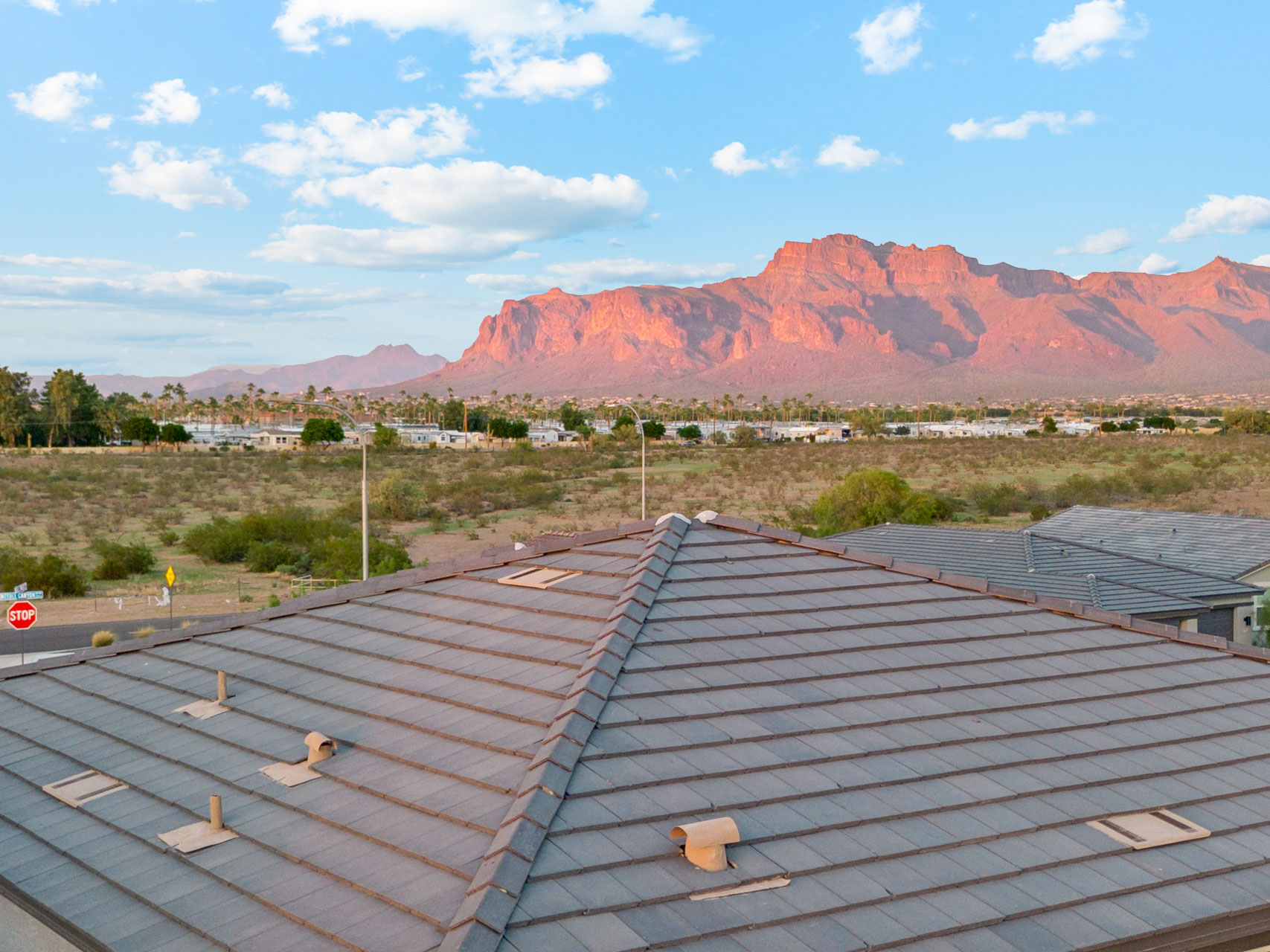 A roof with a mountain in the background.