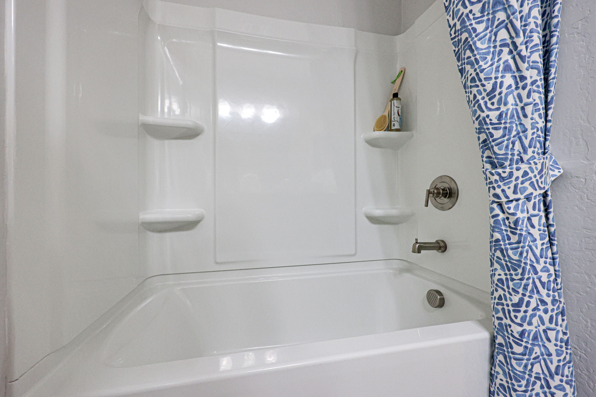 A bathtub with a shower curtain.