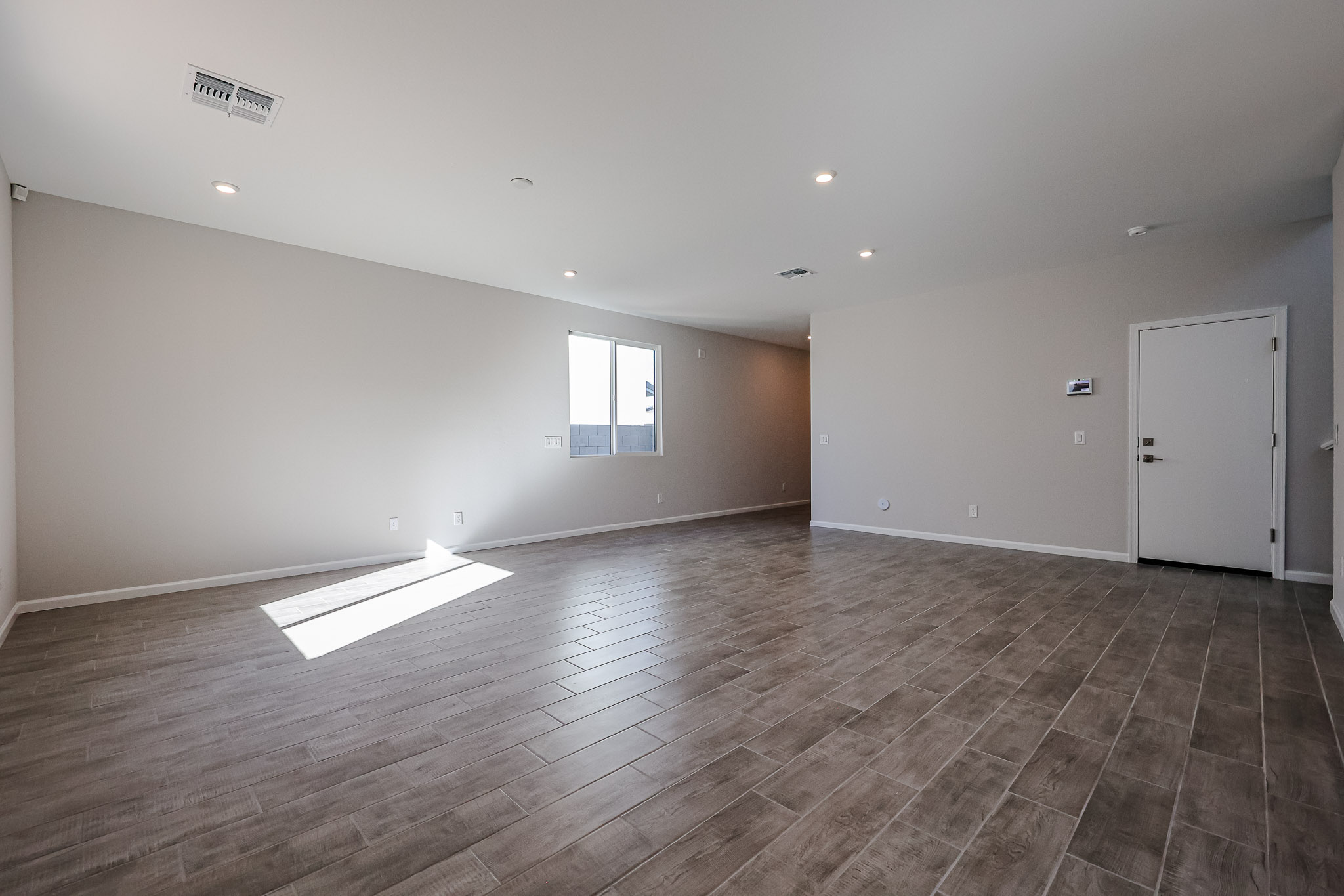 A room with a wood floor and a white door.