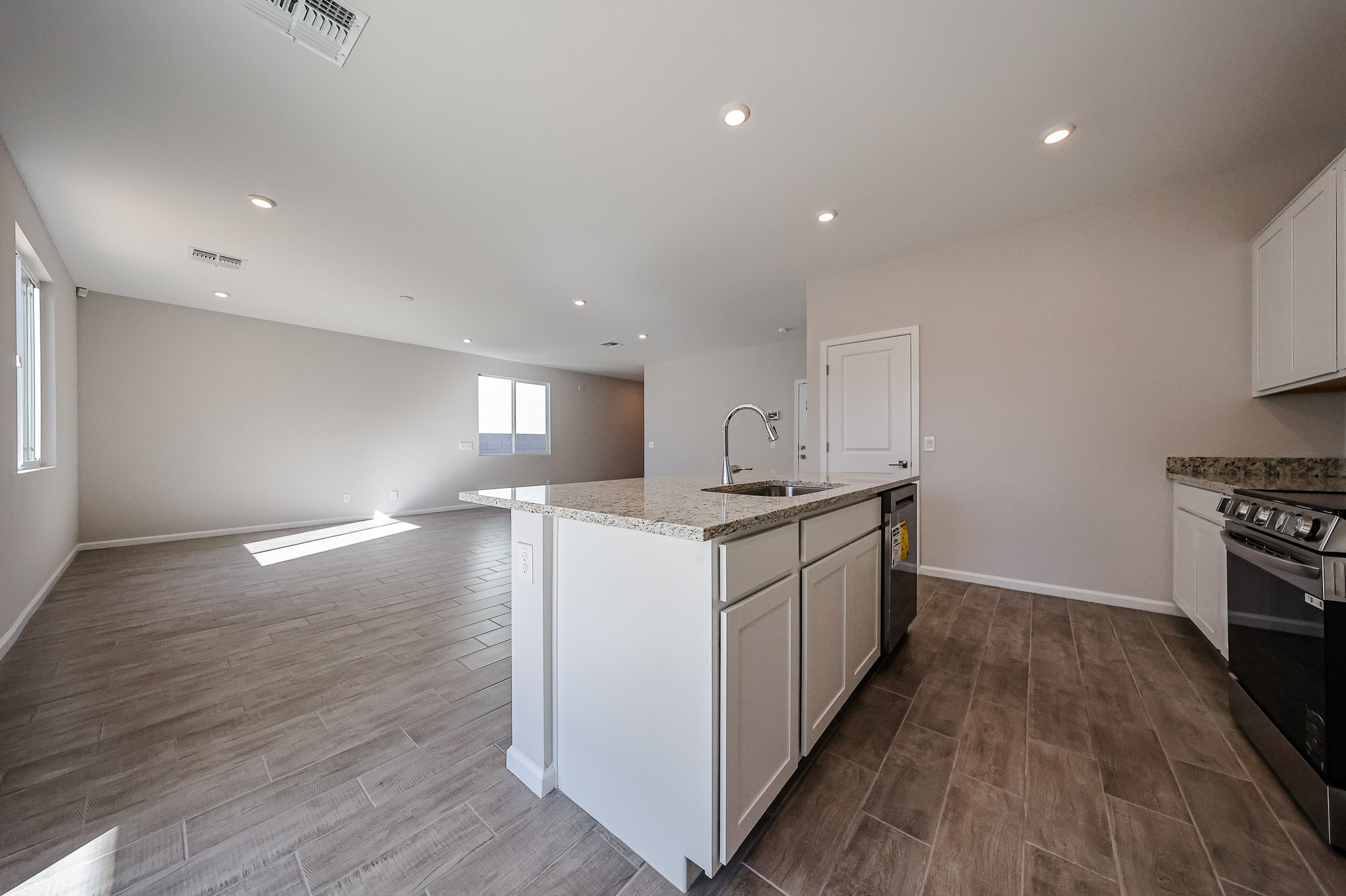 A kitchen with a wood floor.