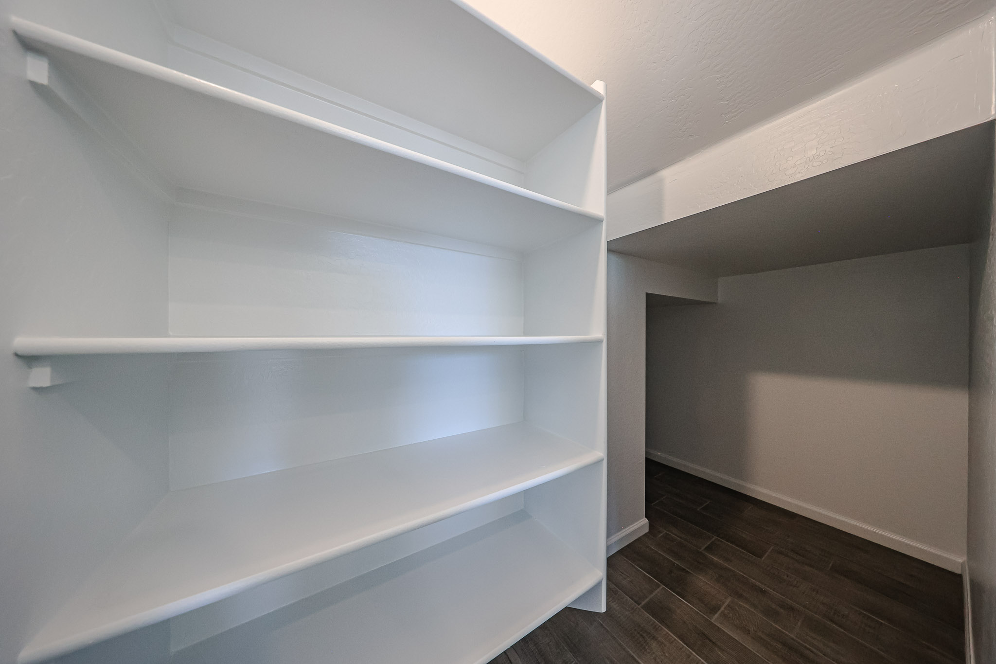 A white shelf in a room.