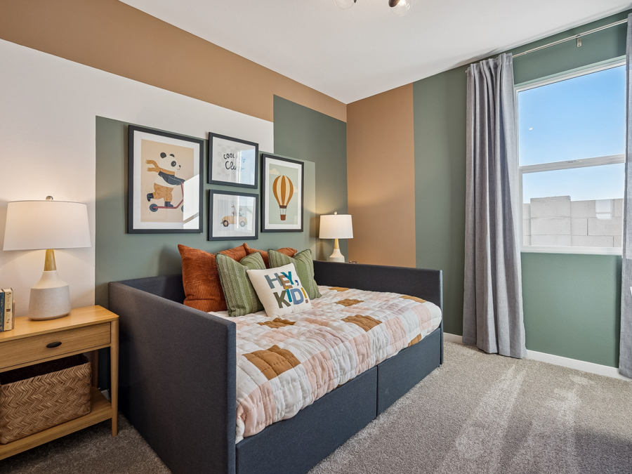 A bedroom with a bed and a window.