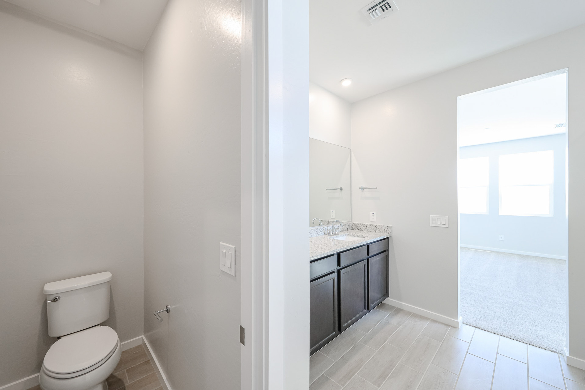 A bathroom with a toilet and sink.