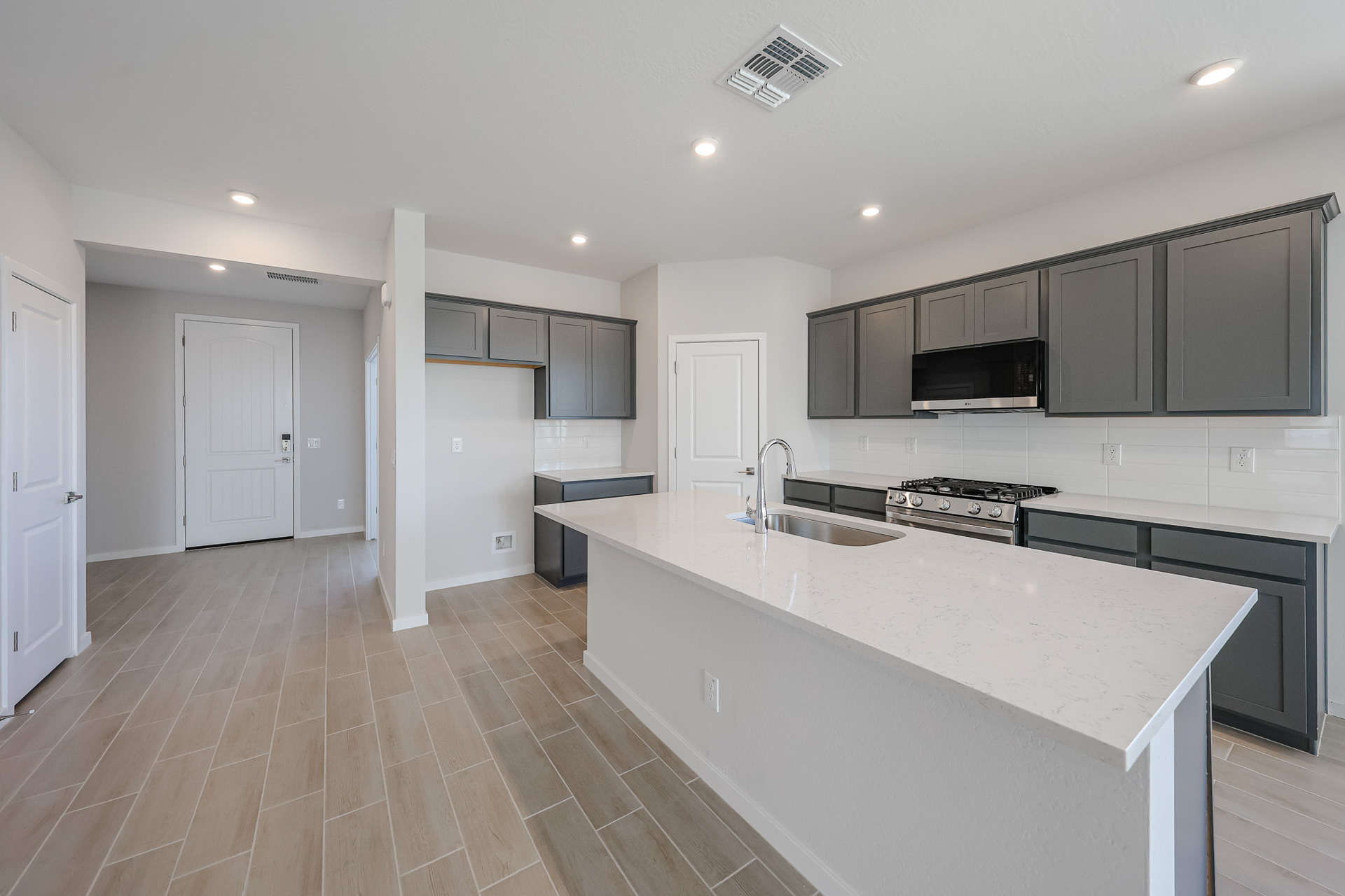 A kitchen with black cabinets.