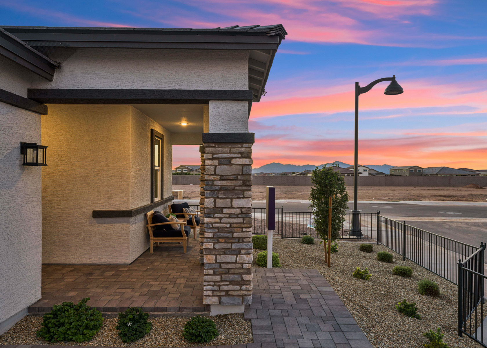 A house with a patio and a patio with a table and chairs.