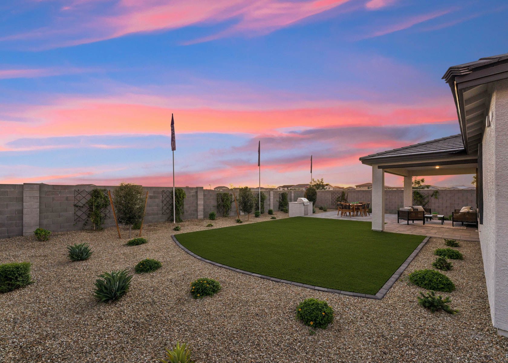 A courtyard with a flag and a building in the background.