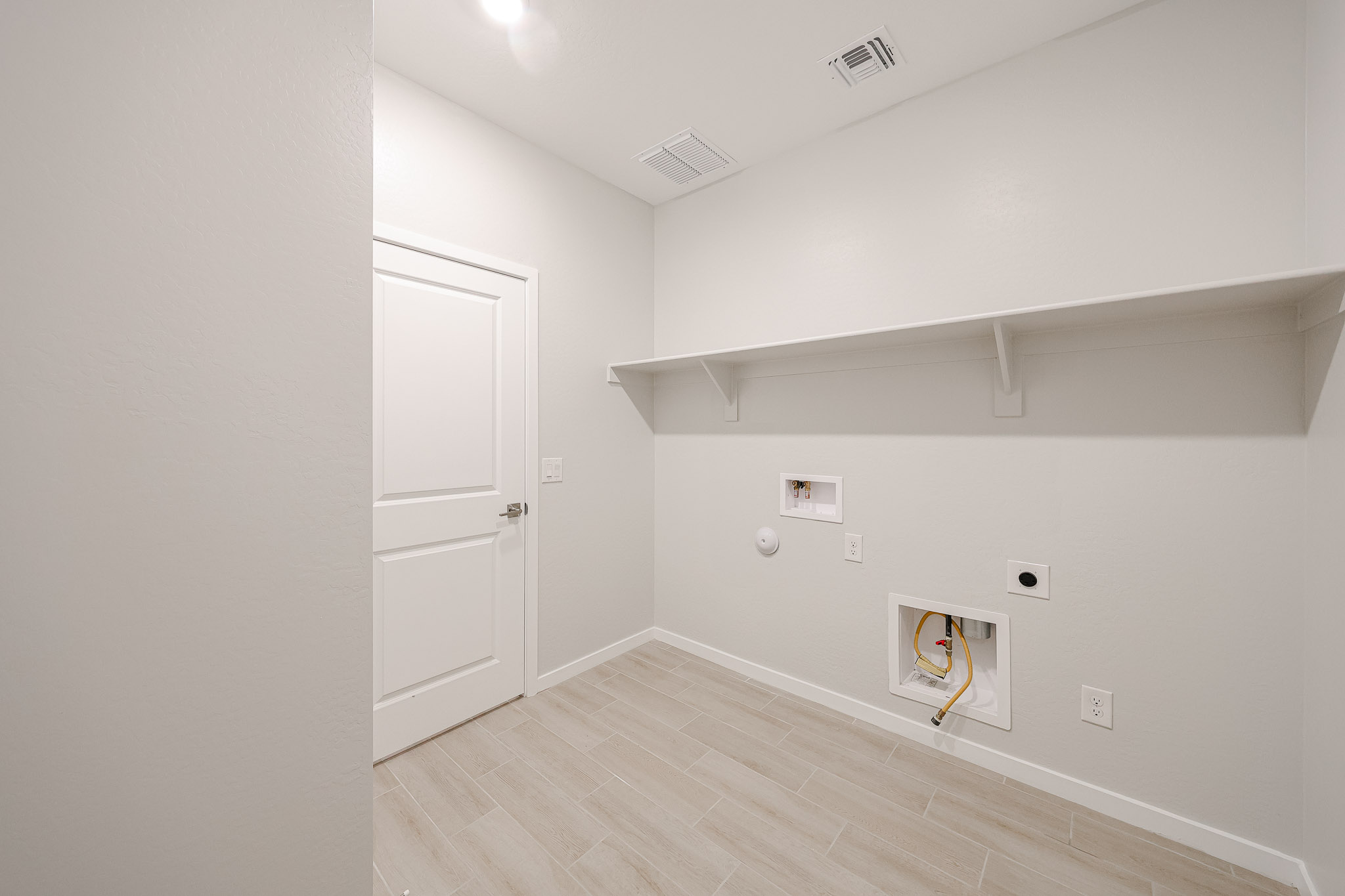 A room with a wood floor and white walls.