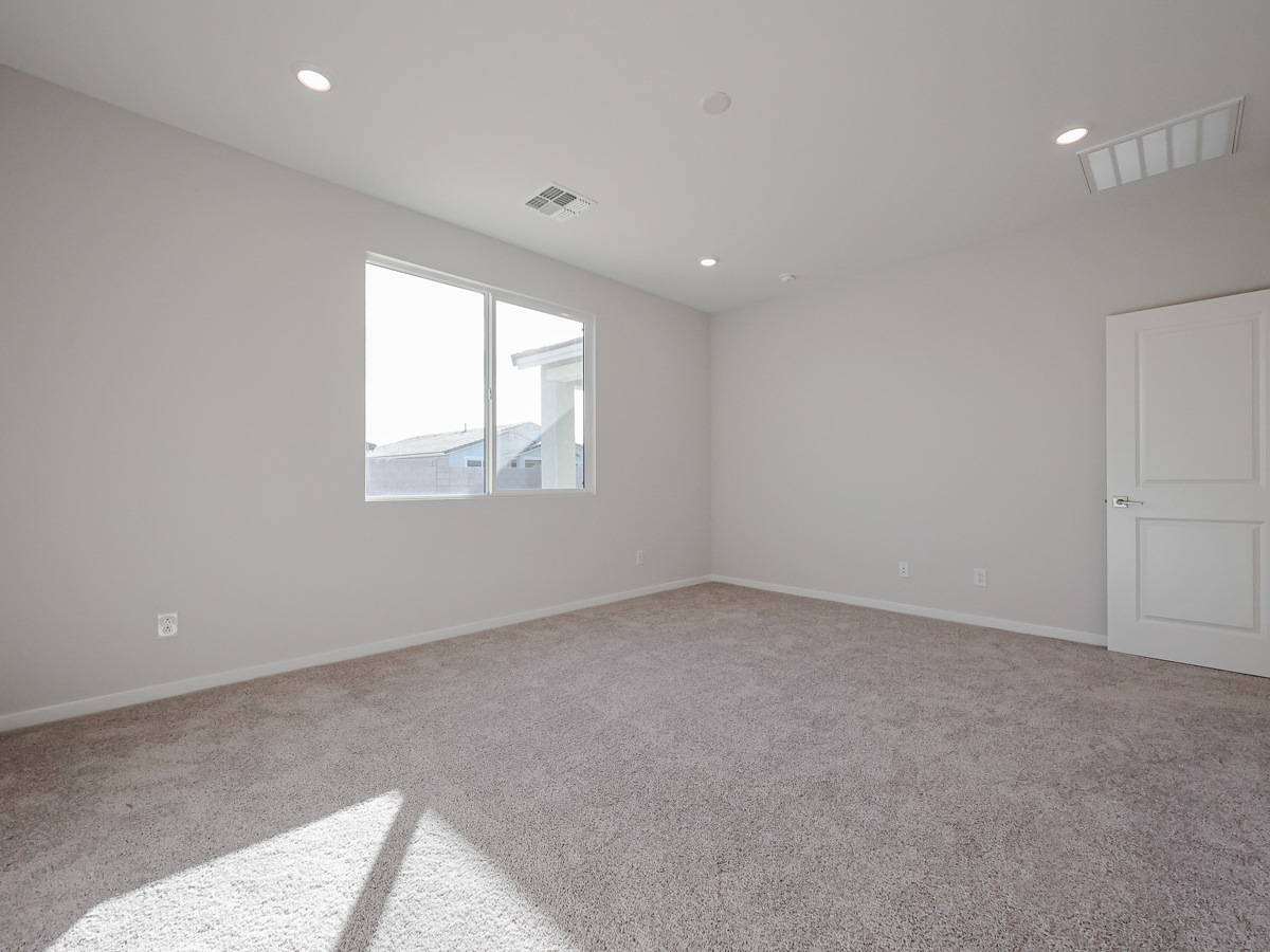 A room with a window and a carpet.