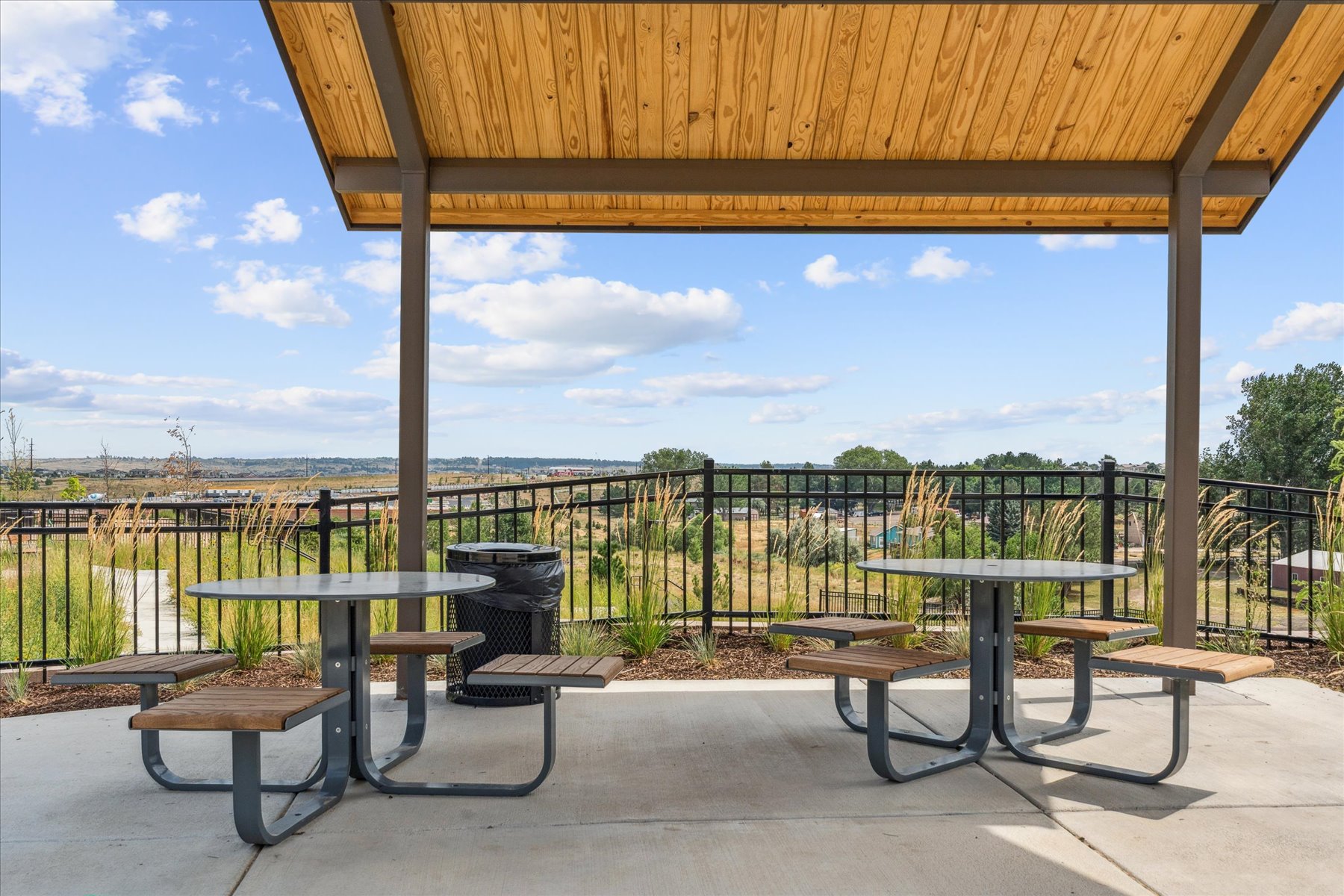 A picnic table and chairs on a deck.