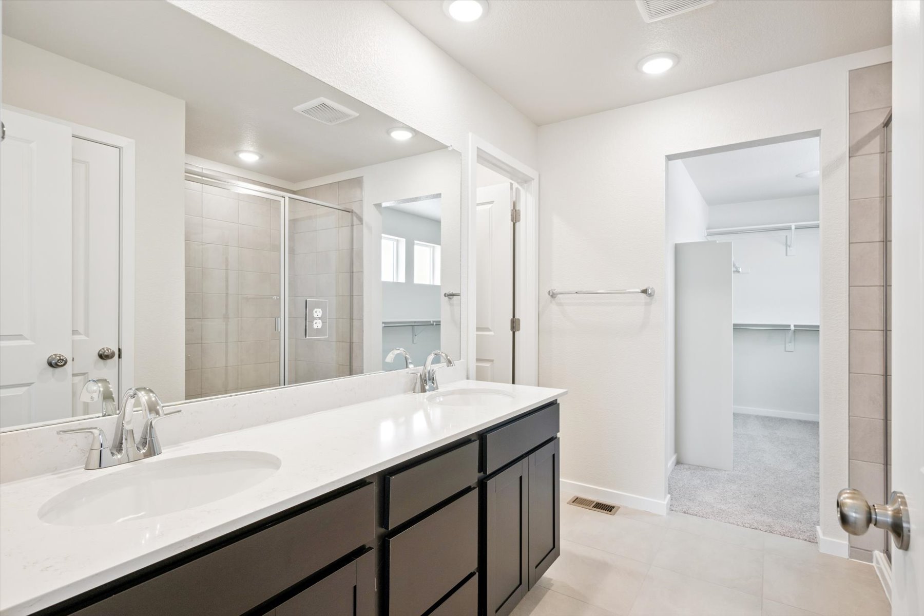 A bathroom with a large mirror.
