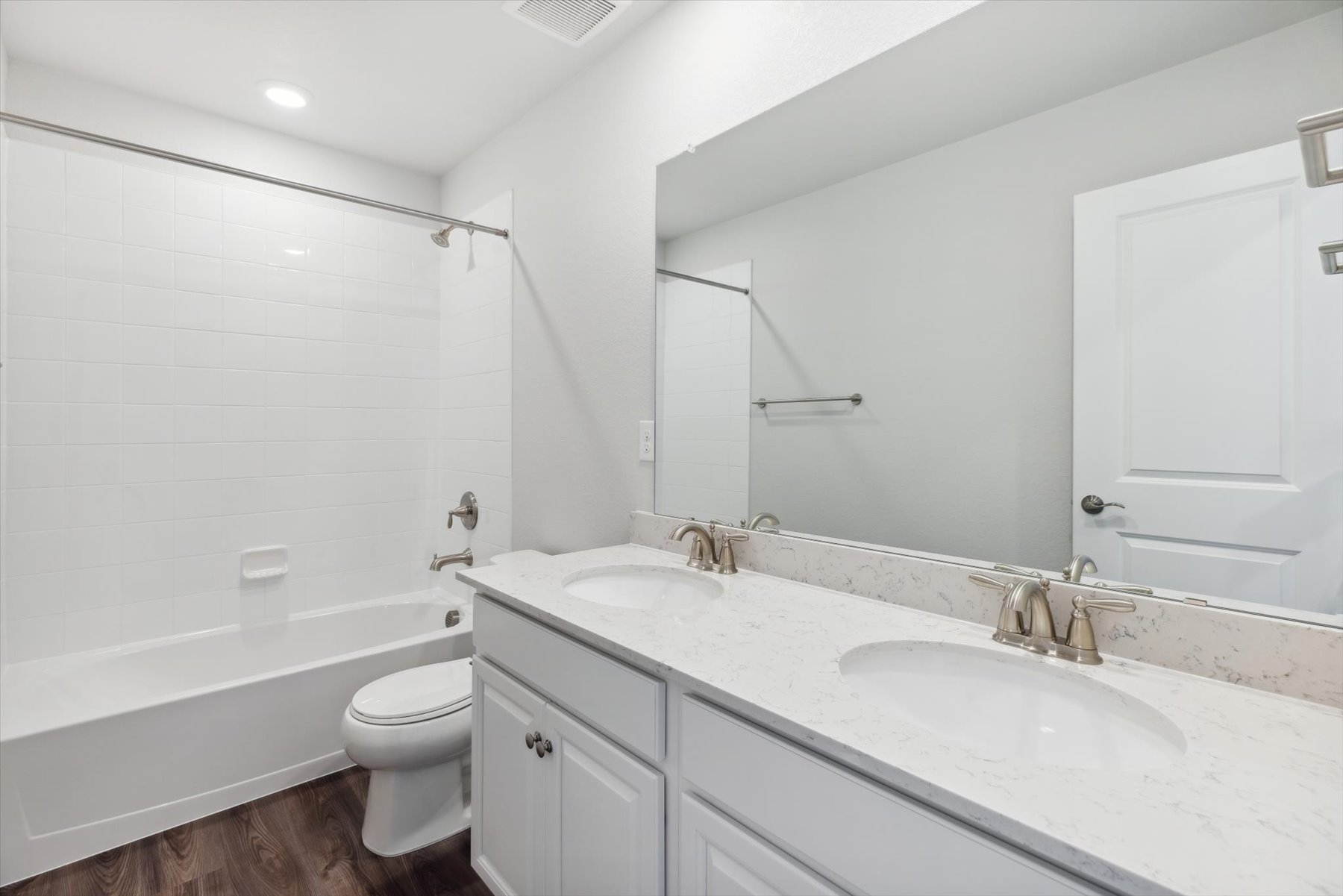 A bathroom with a tub sink and toilet.