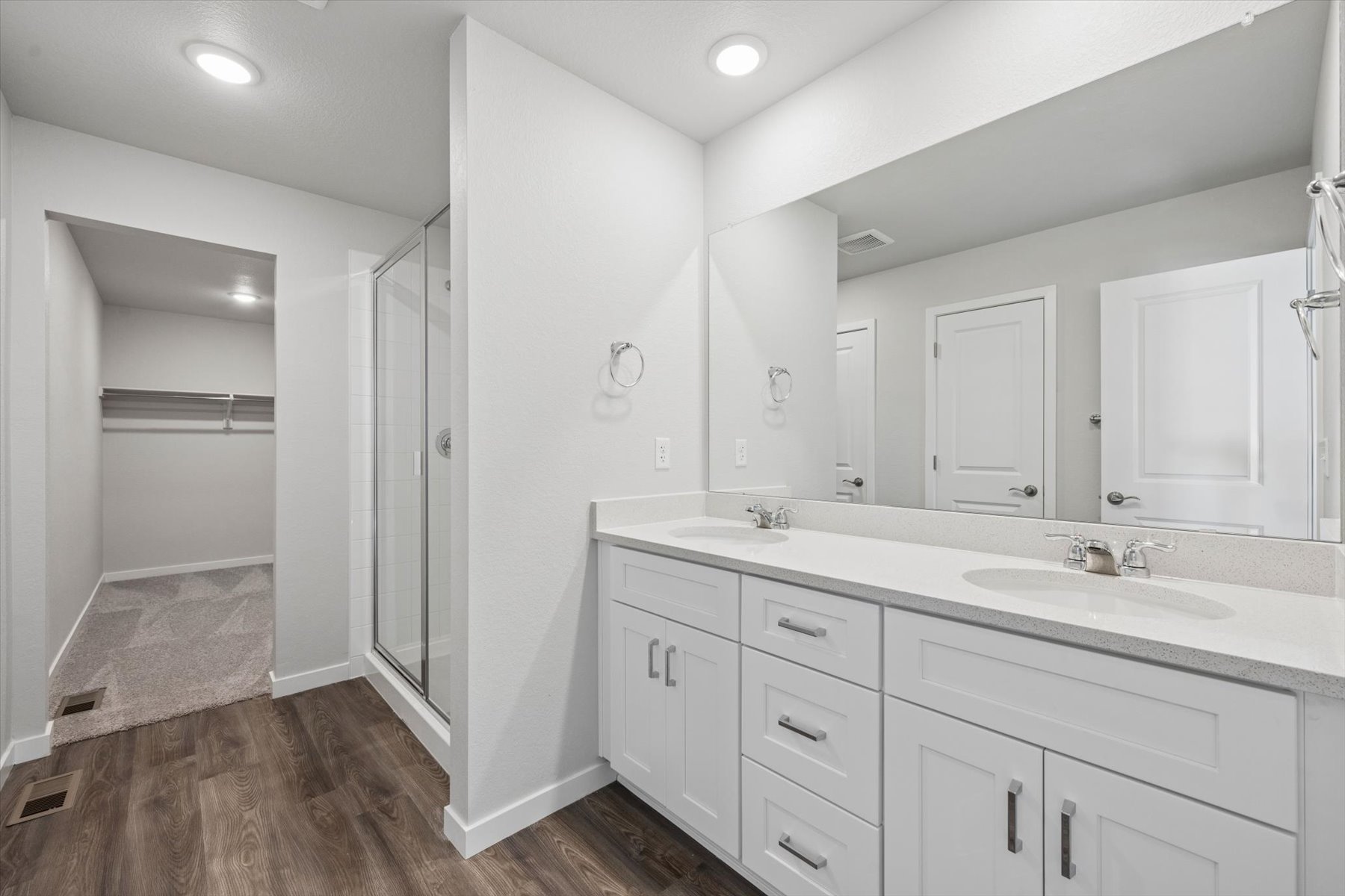 A bathroom with white cabinets.