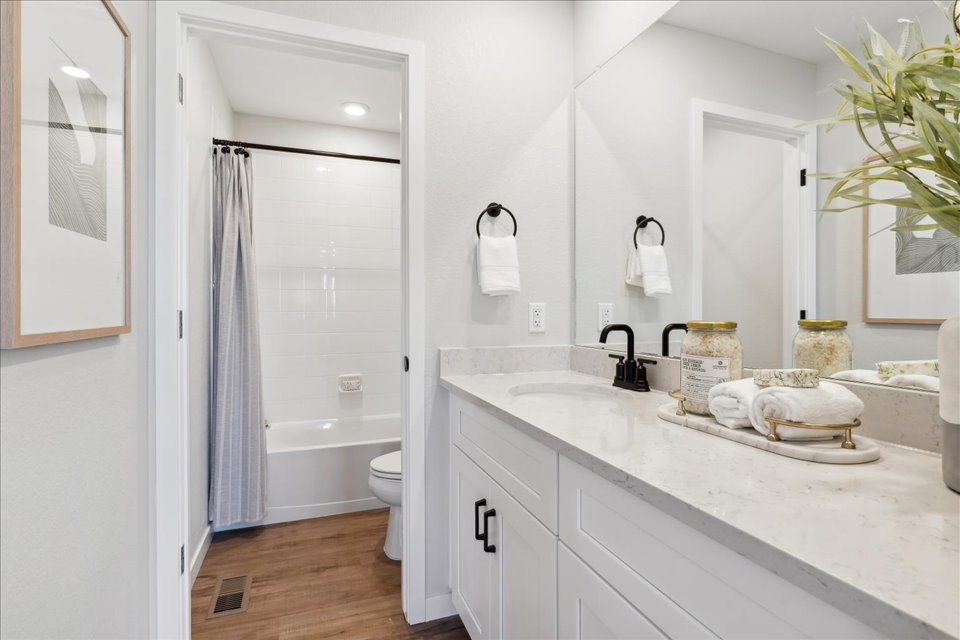A bathroom with a tub sink and toilet.