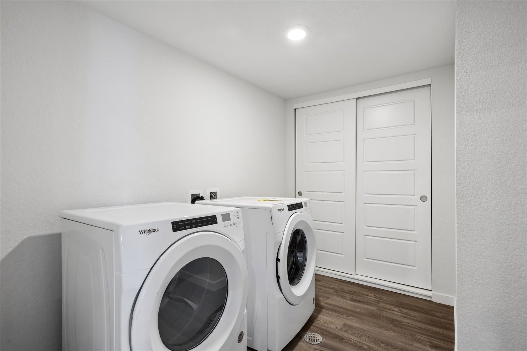 A white washing machine in a room.