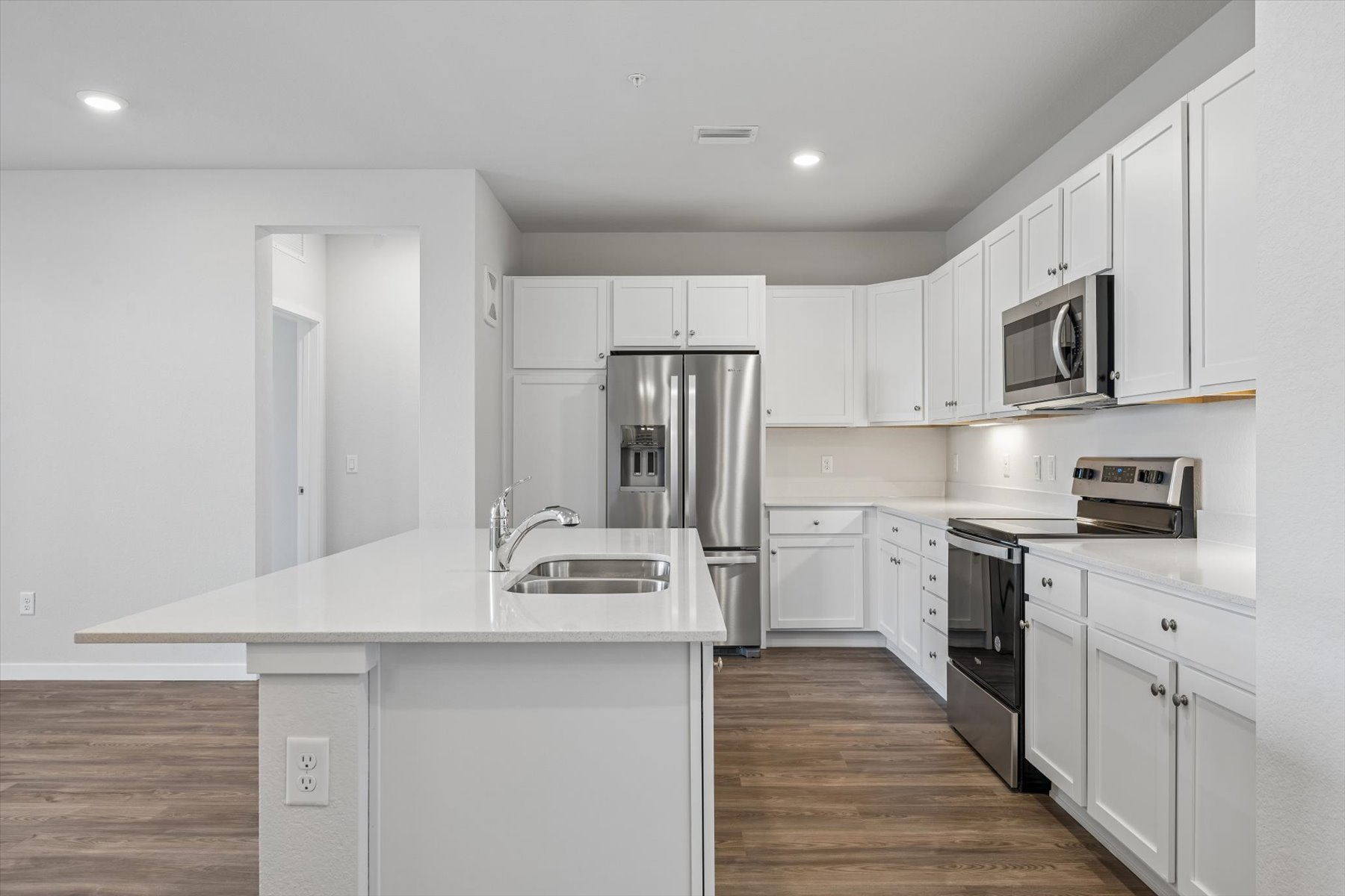 A kitchen with white cabinets.