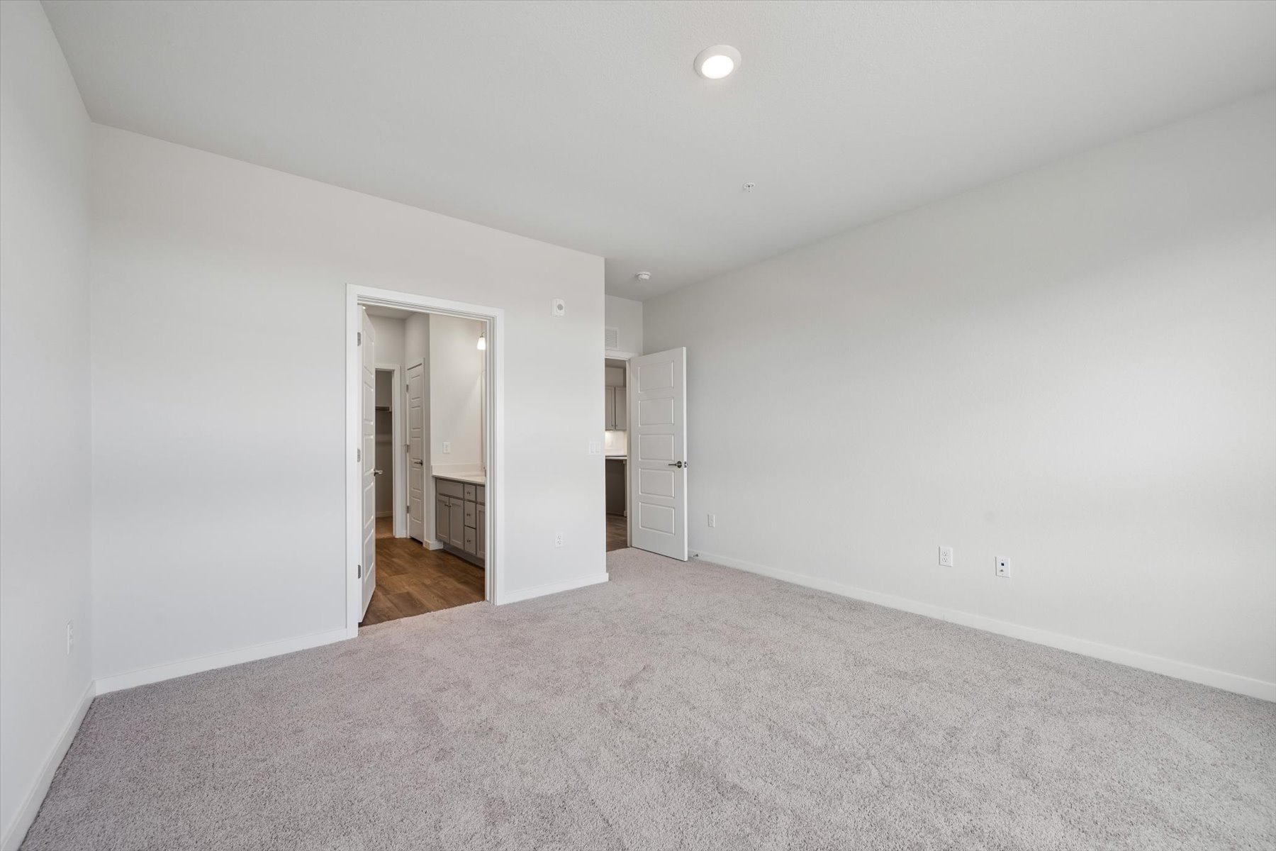 A hallway with white walls.