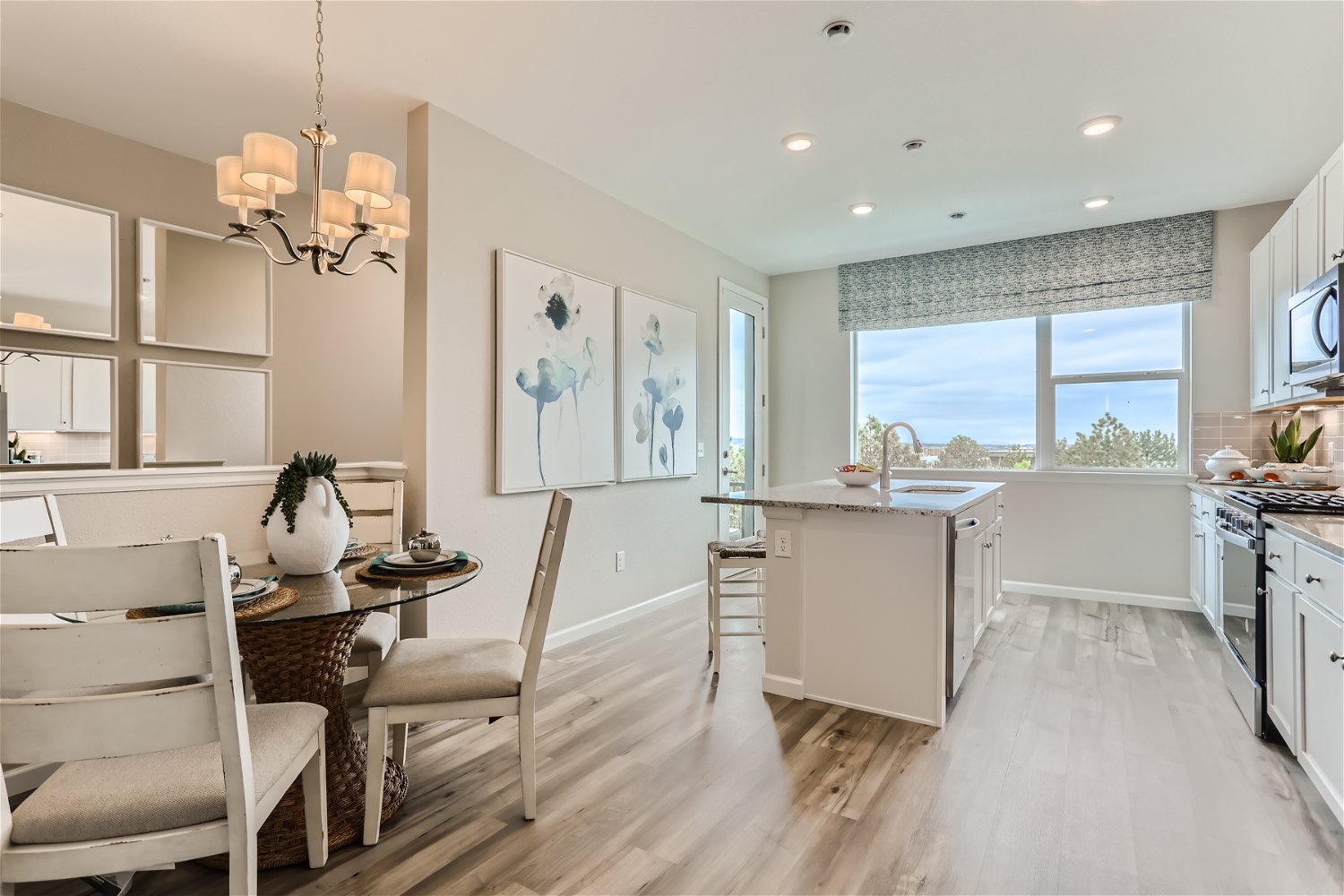 A kitchen with a large window.