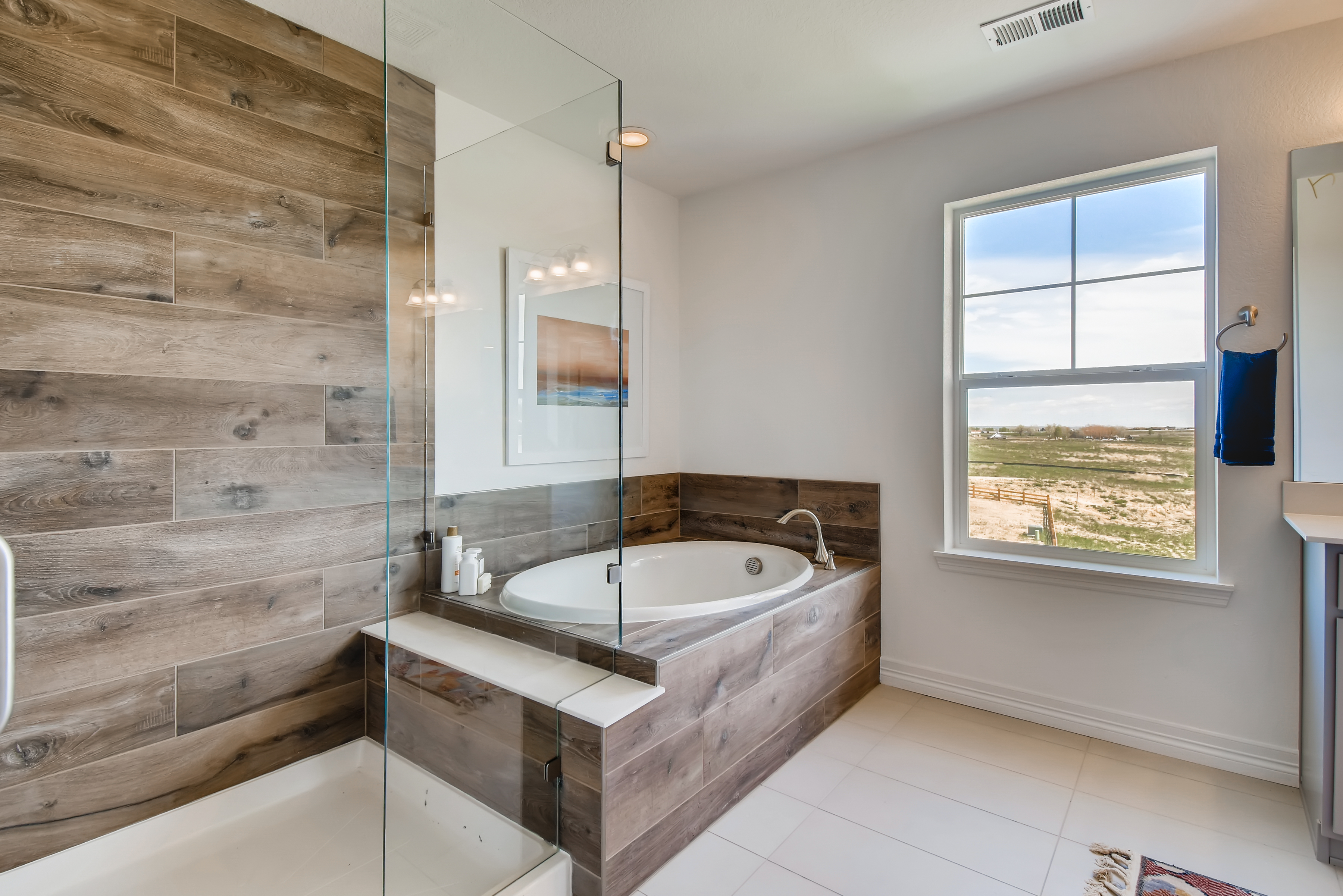A bathroom with a tub and a window.