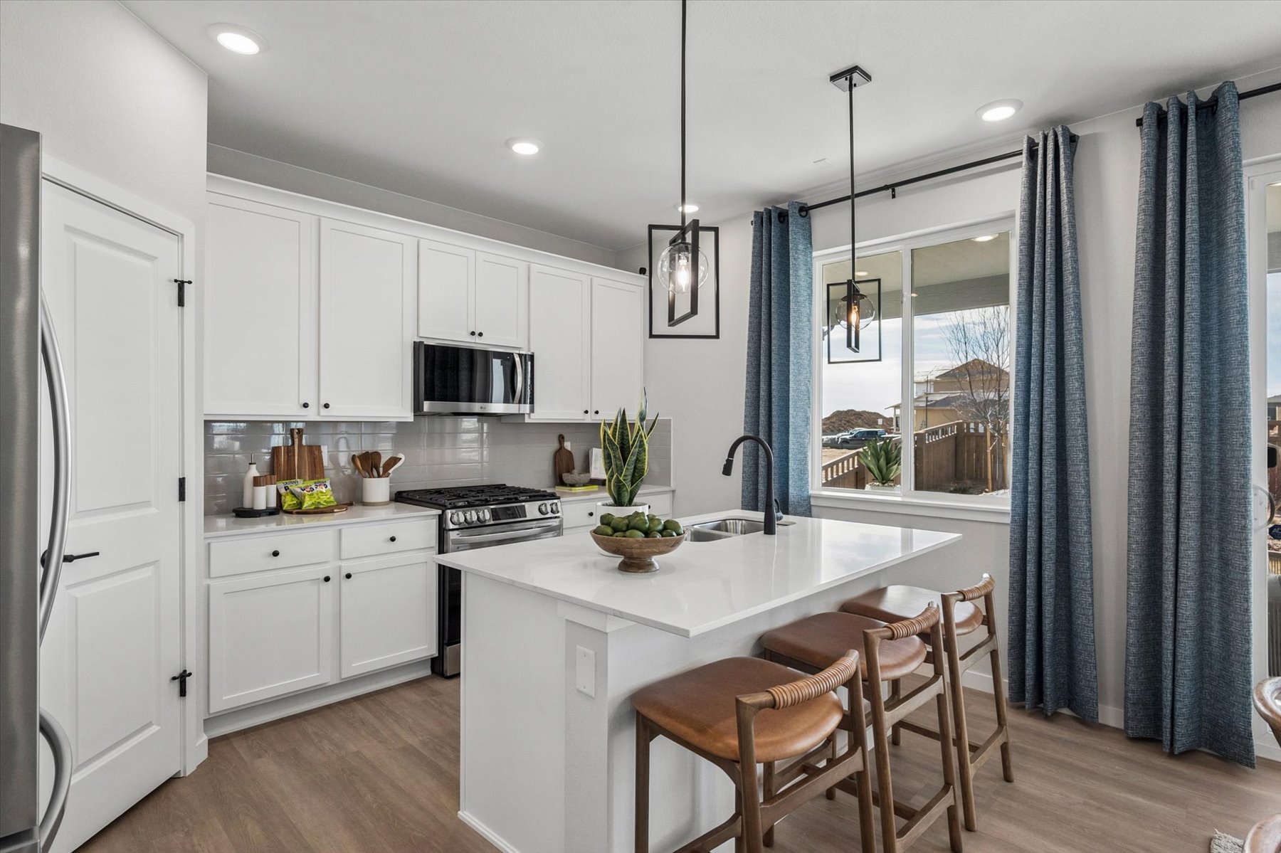 A kitchen with white cabinets.