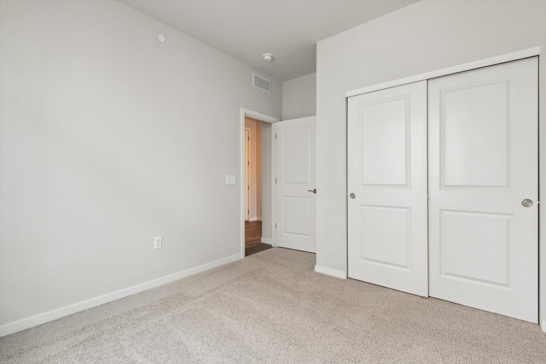 A hallway with white doors.