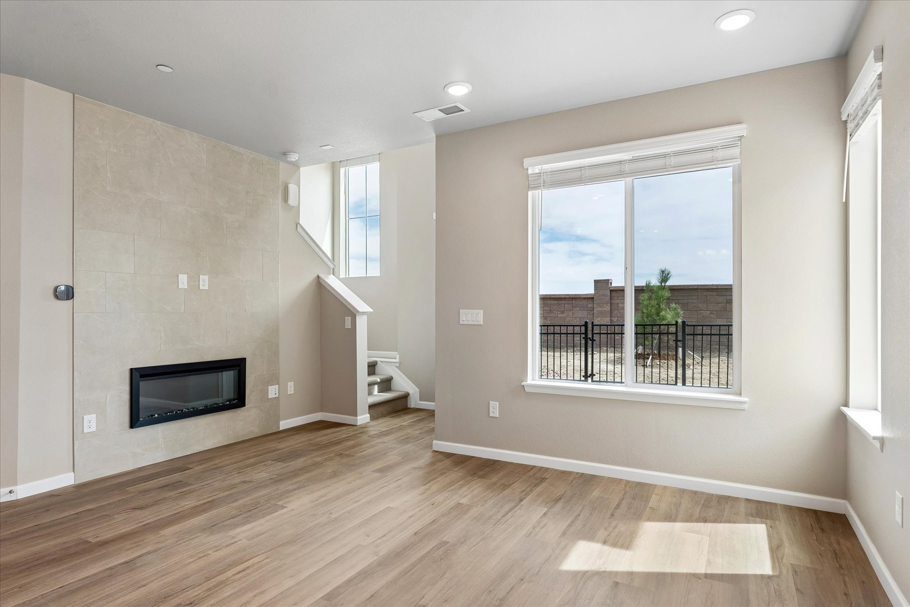 A room with a fireplace and a wood floor.