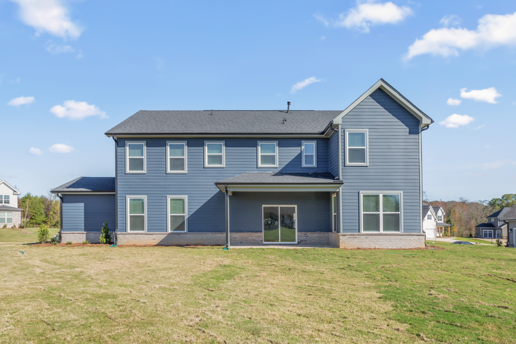 A blue house with a grass yard.
