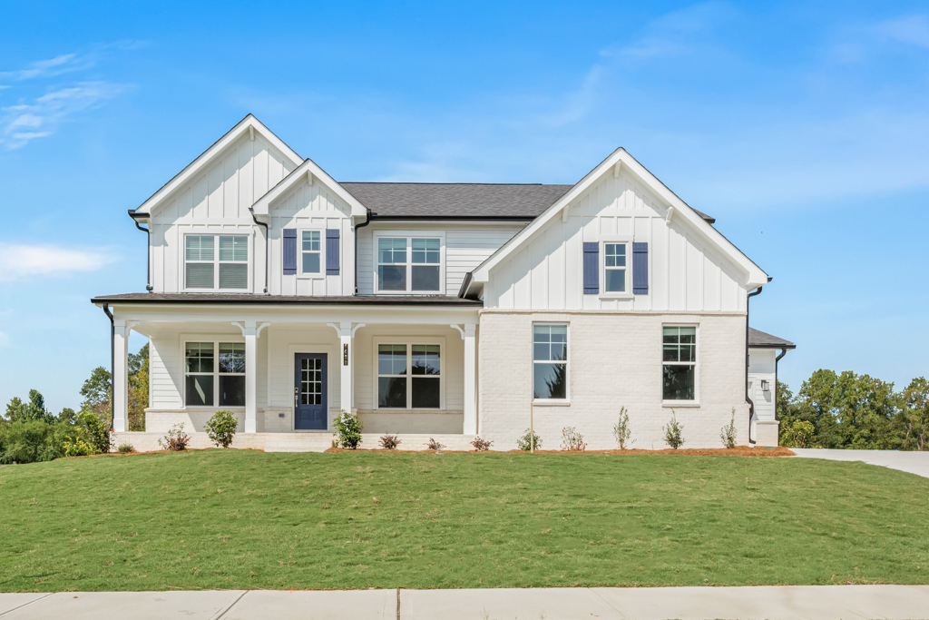 A white house with a lawn.