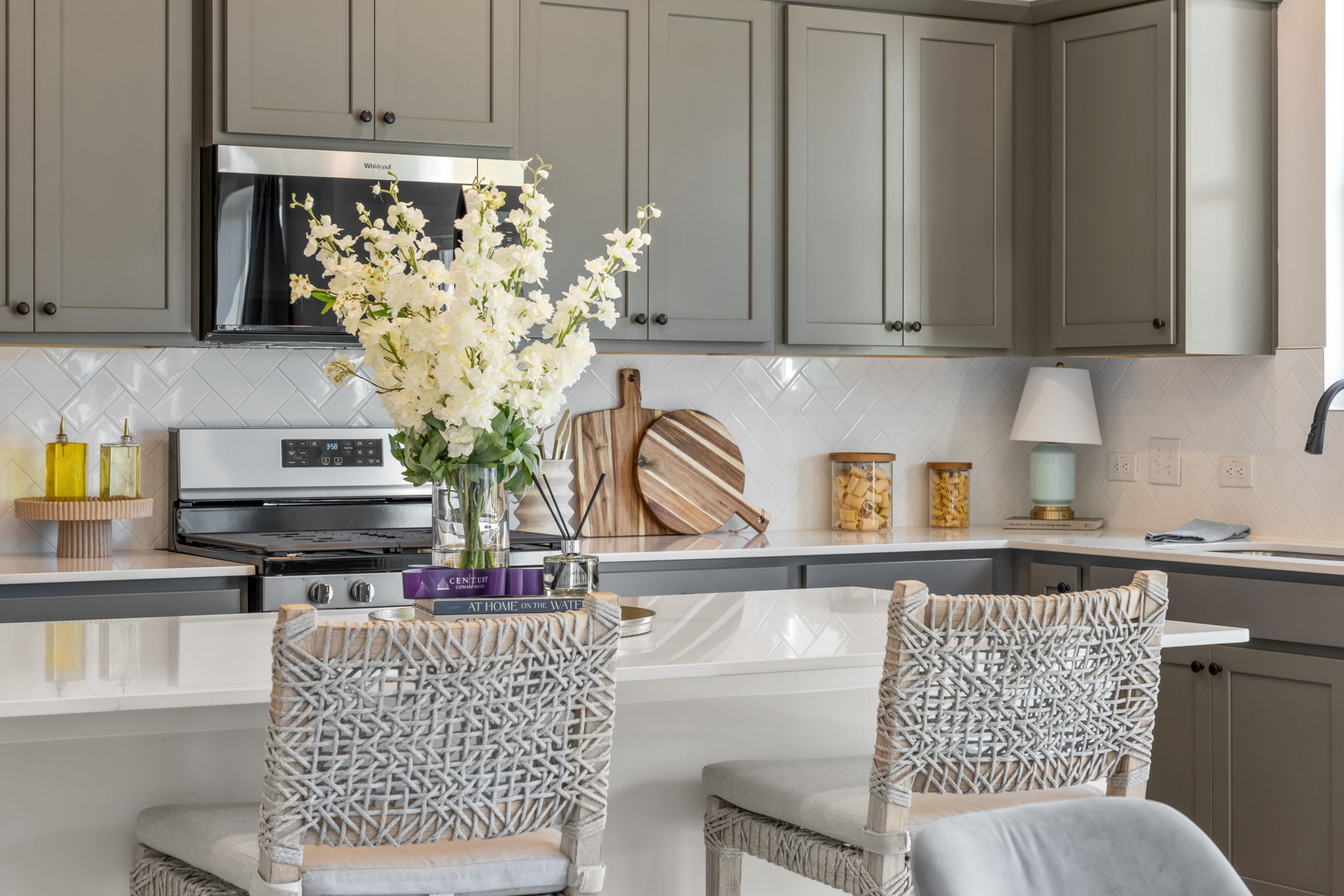 A kitchen with white cabinets.