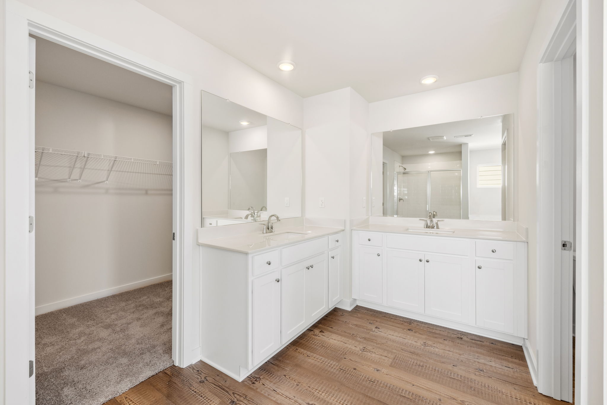 A bathroom with white cabinets.