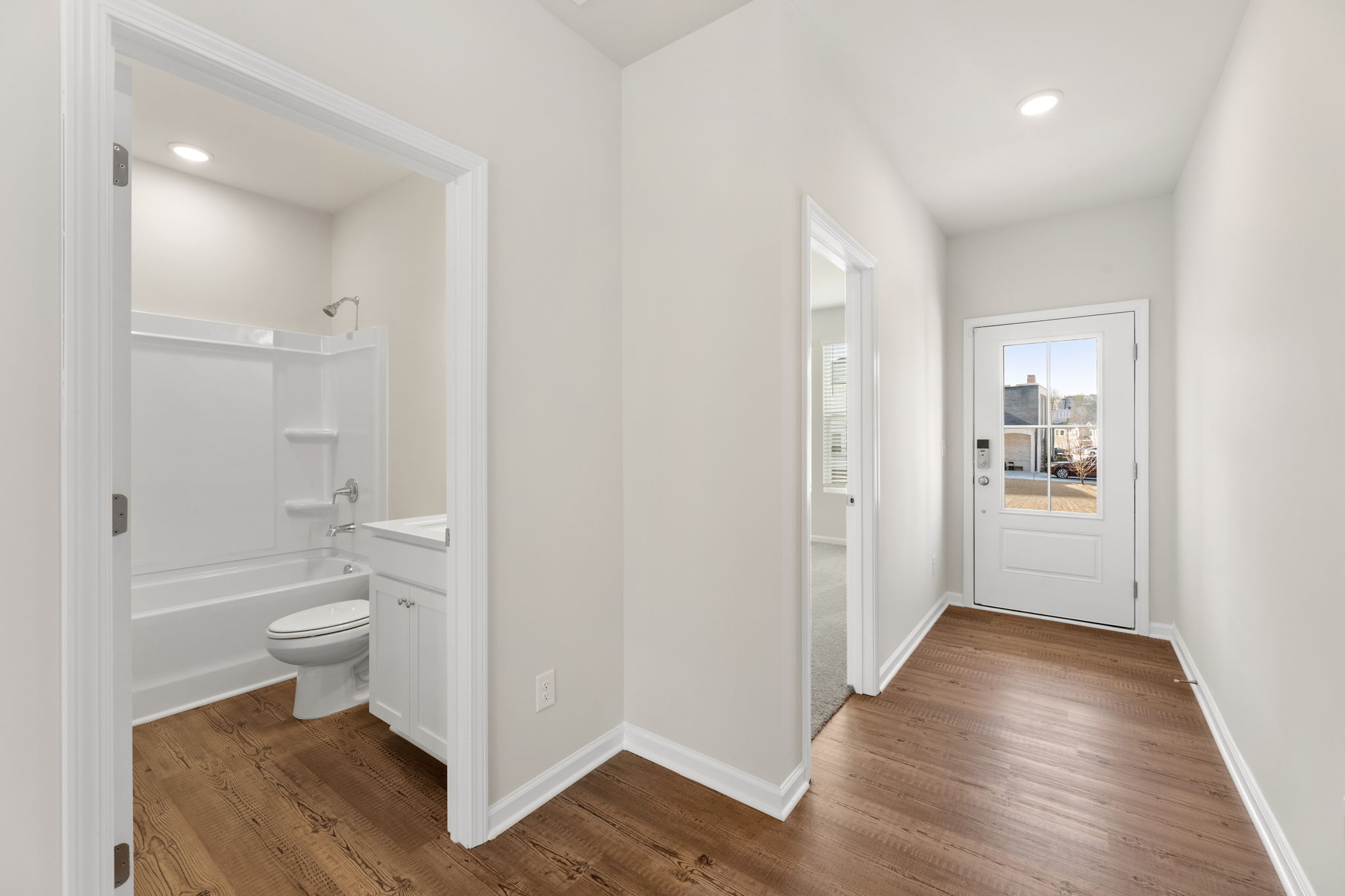 A bathroom with a wood floor.