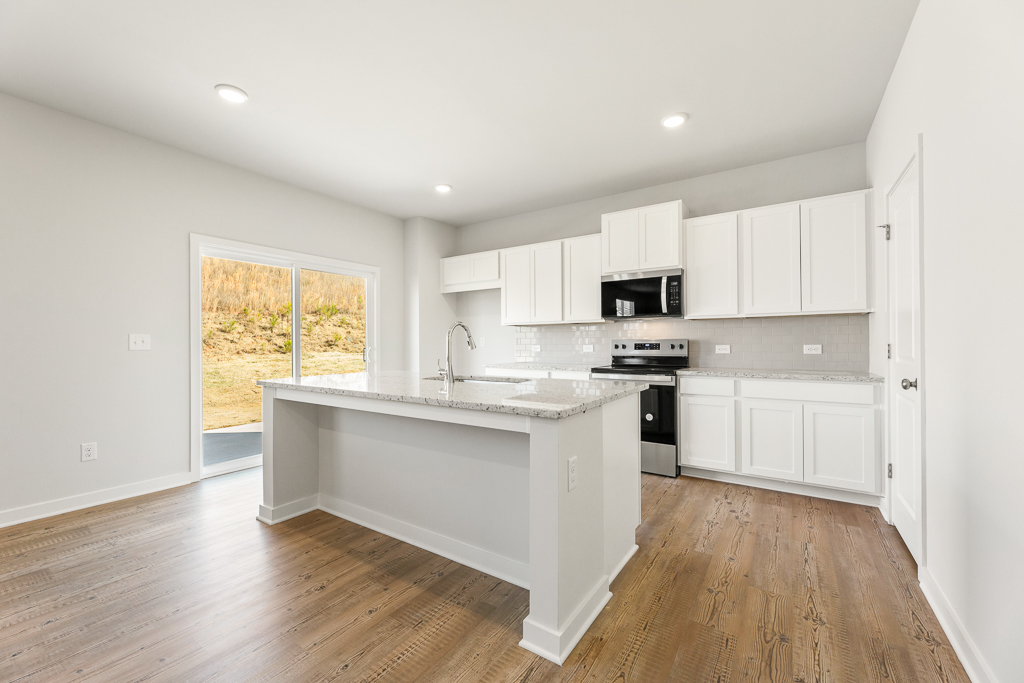 A kitchen with white cabinets.