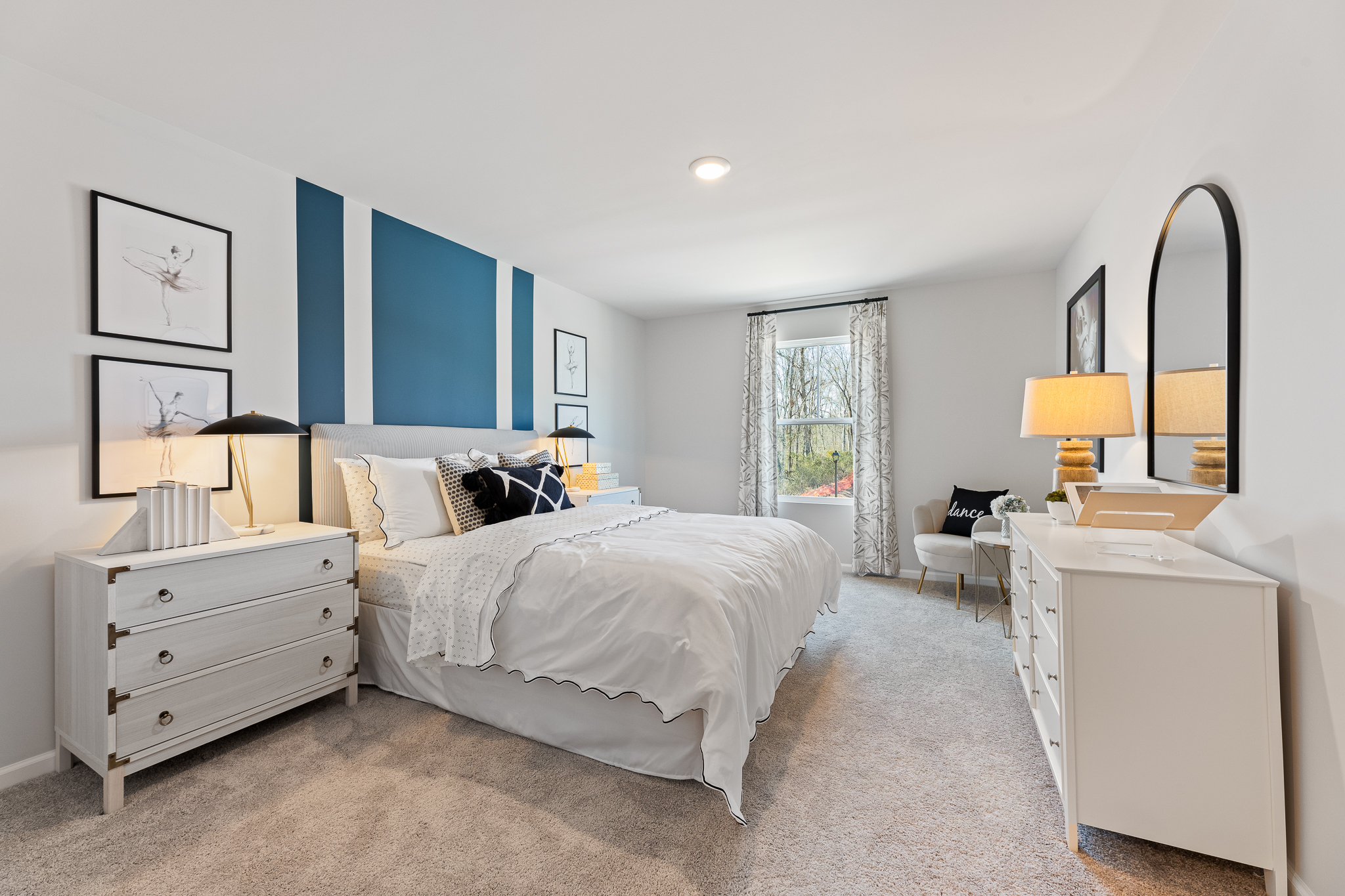 A bedroom with a bed and dresser.