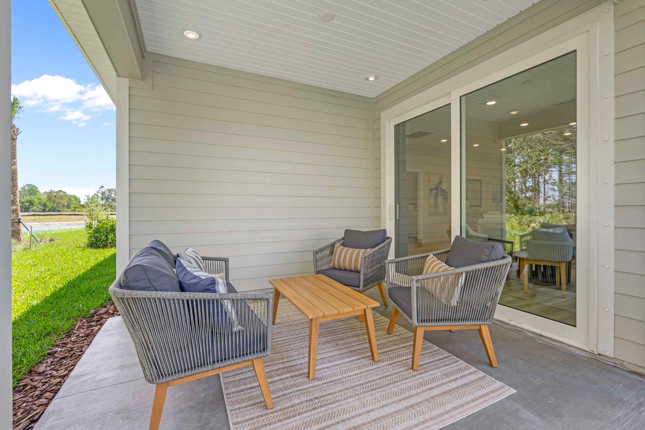 Coronado Model Home Covered Patio with Chairs and Table at Reserve East in Flagler Beach