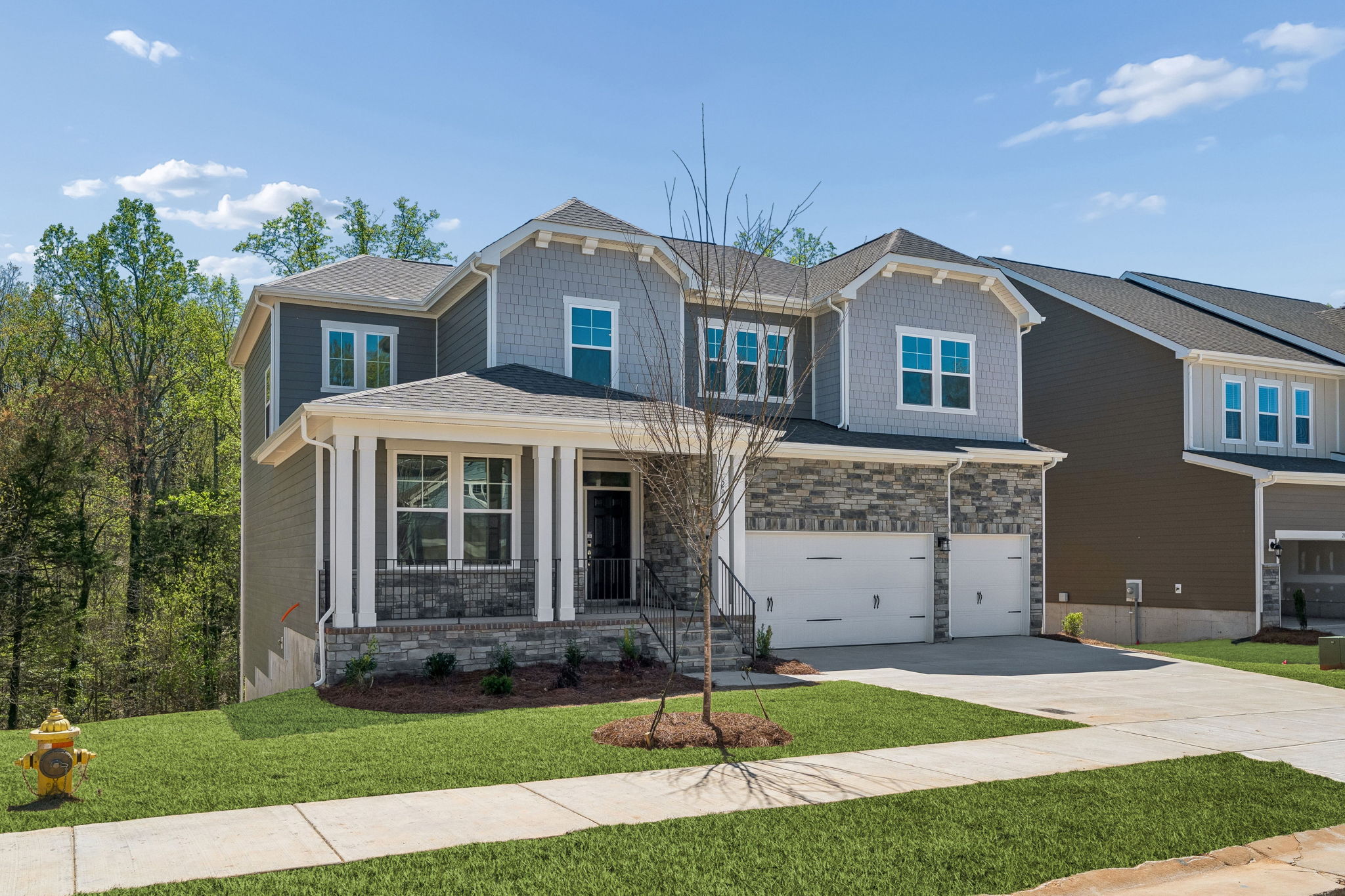 A large house with a tree in the front.
